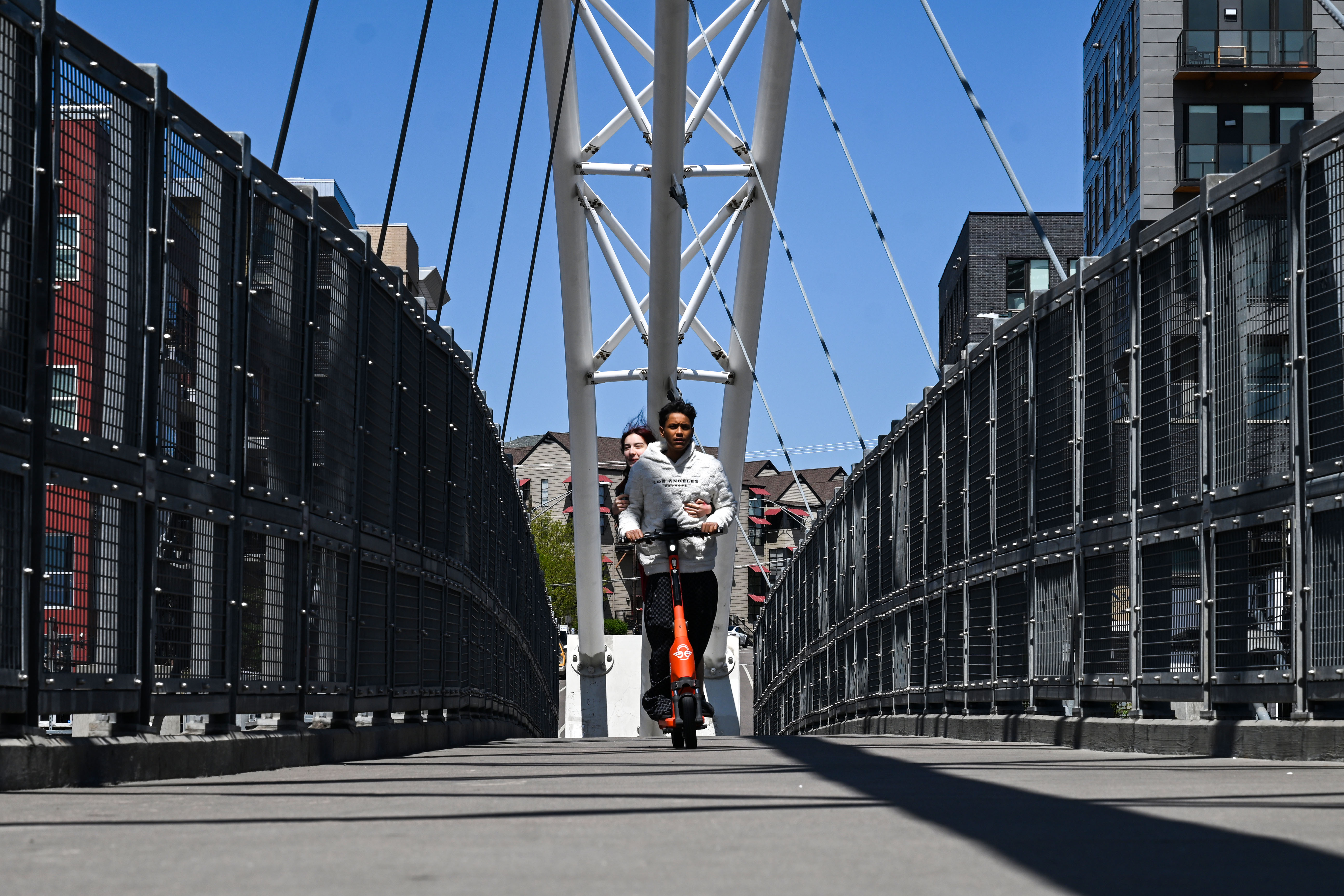 Chuy Ortega and Jocelyn Alba, both 14, ride a rental scooter across the Highland Bridge in downtown Denver on Tuesday, April 29, 2025. (Stephen Swofford, Denver Gazette) (StephenSwoffordPhotographerstephen.swofford@gazette.comhttps://secure.gravatar.com/avatar/1ddcaf11c5d70eaa58546ddc4e038687?d=mm&r=g)