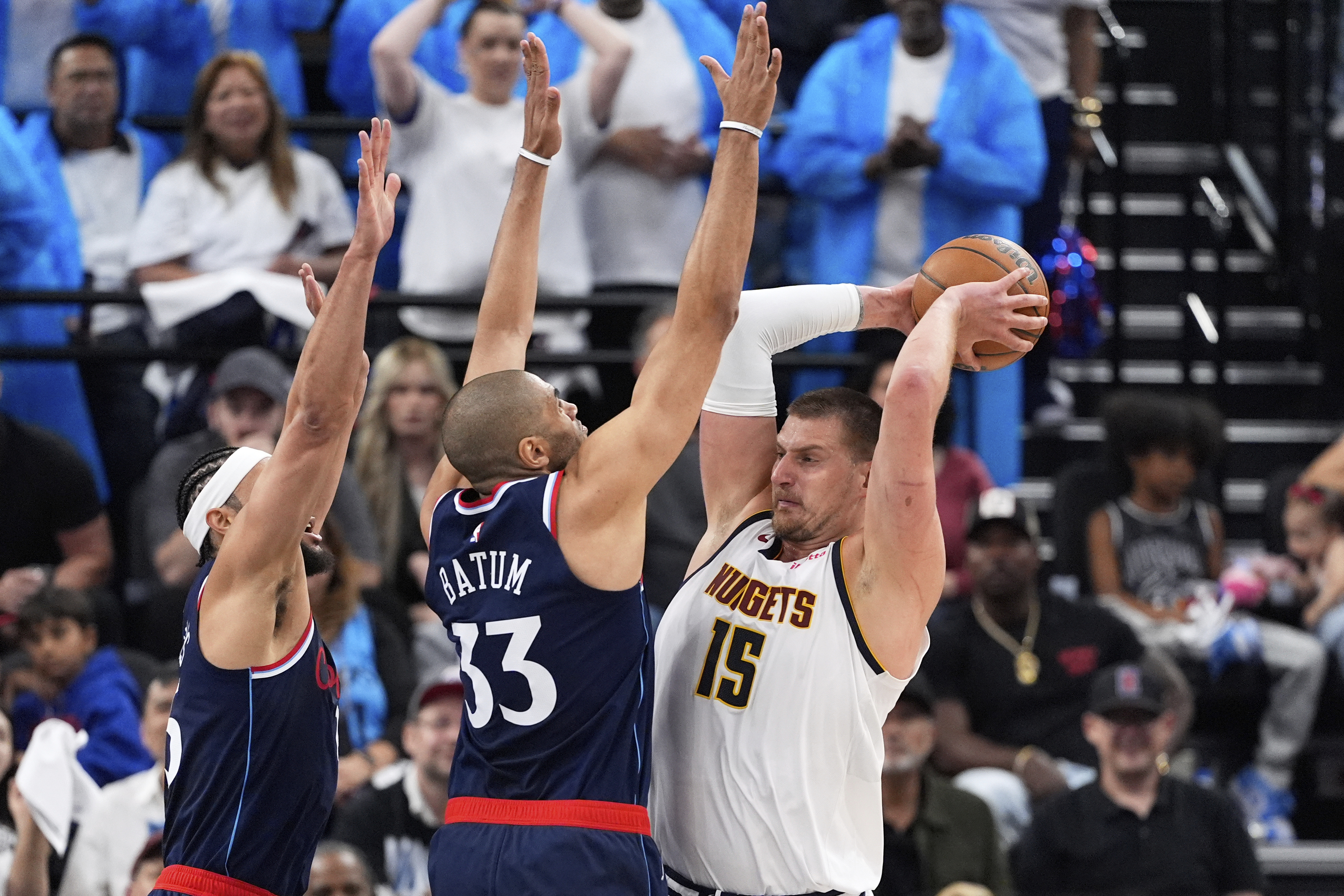 Denver Nuggets center Nikola Jokic, right, tries to pass while under pressure from Los Angeles Clippers guard Ben Simmons, left, and forward Nicolas Batum during the first half in Game 3 of an NBA basketball first-round playoff series Thursday, April 24, 2025, in Inglewood, Calif. (AP Photo/Mark J. Terrill) (Mark J. Terrill)
