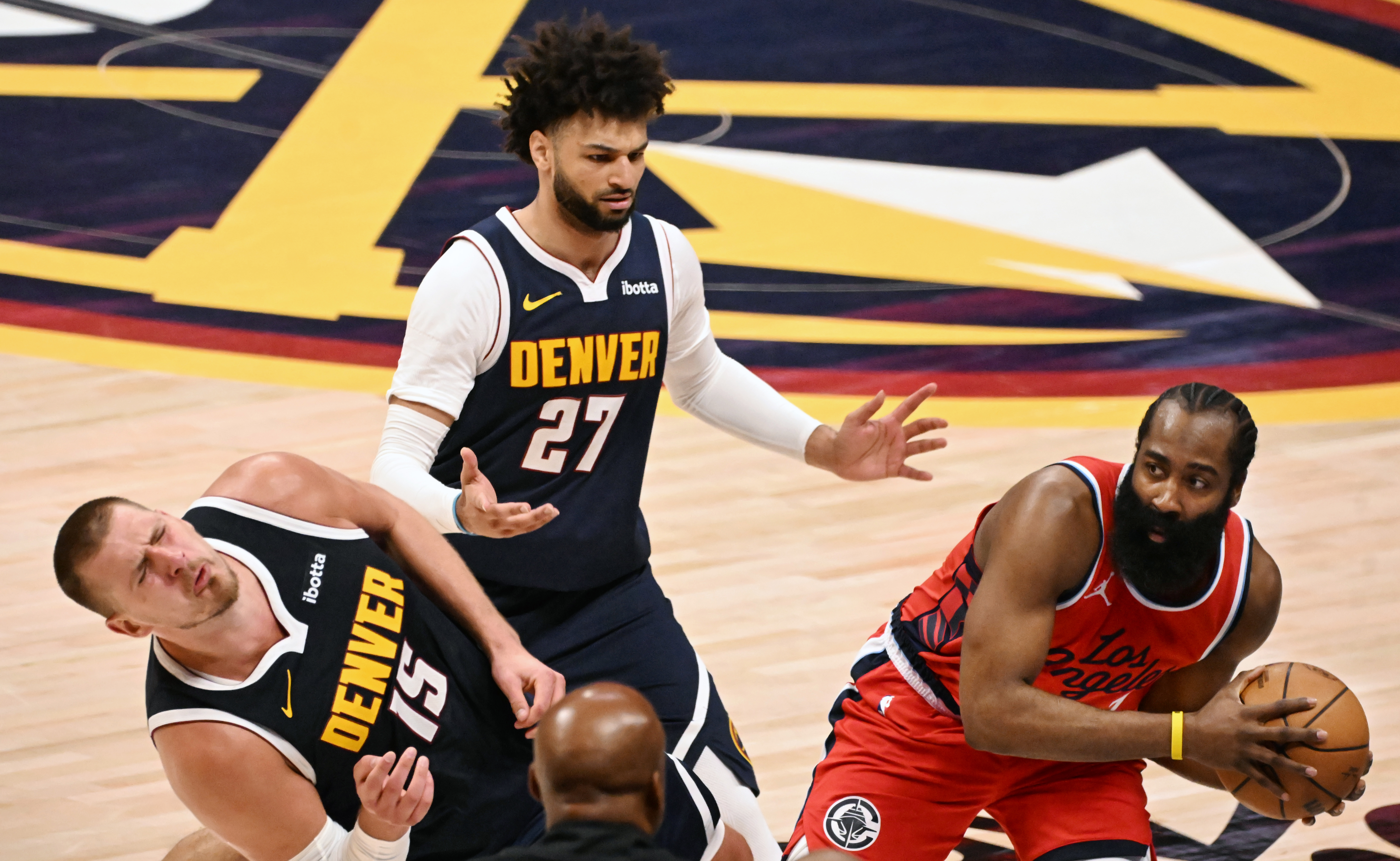 Denver Nuggets center Nikola Jokic (15) falls to the ground after getting bumped by LA Clippers guard James Harden (1), but there is no foul, during the 4th quarter of game 2 of Round 1 of the NBA Western Championship at Ball Arena on Monday, April 21, 2025. (Jerilee Bennett, The Gazette)