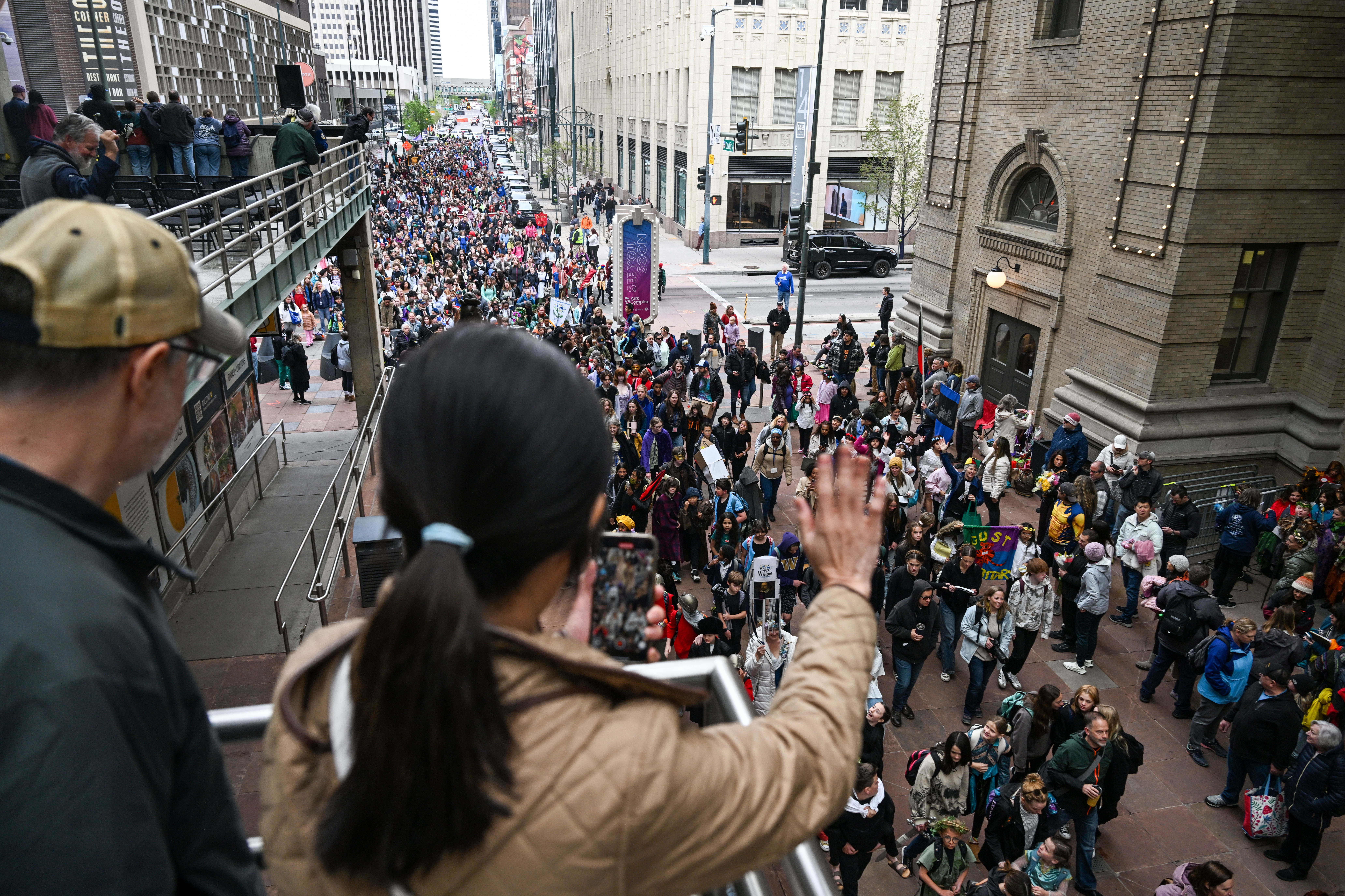 Parents, friends, and family watch from a parking structure as 5,000 students of all ages from Denver Public Schools march from Skyline park to the Denver Center for Performing Arts during the opening parade to kick off the 41st Annual DPS Shakespeare Festival on Friday, April 25, 2025. The festival is the oldest and largest student Shakespeare festival in the country. (Stephen Swofford, Denver Gazette) (StephenSwoffordPhotographerstephen.swofford@gazette.comhttps://secure.gravatar.com/avatar/1ddcaf11c5d70eaa58546ddc4e038687?d=mm&r=g)