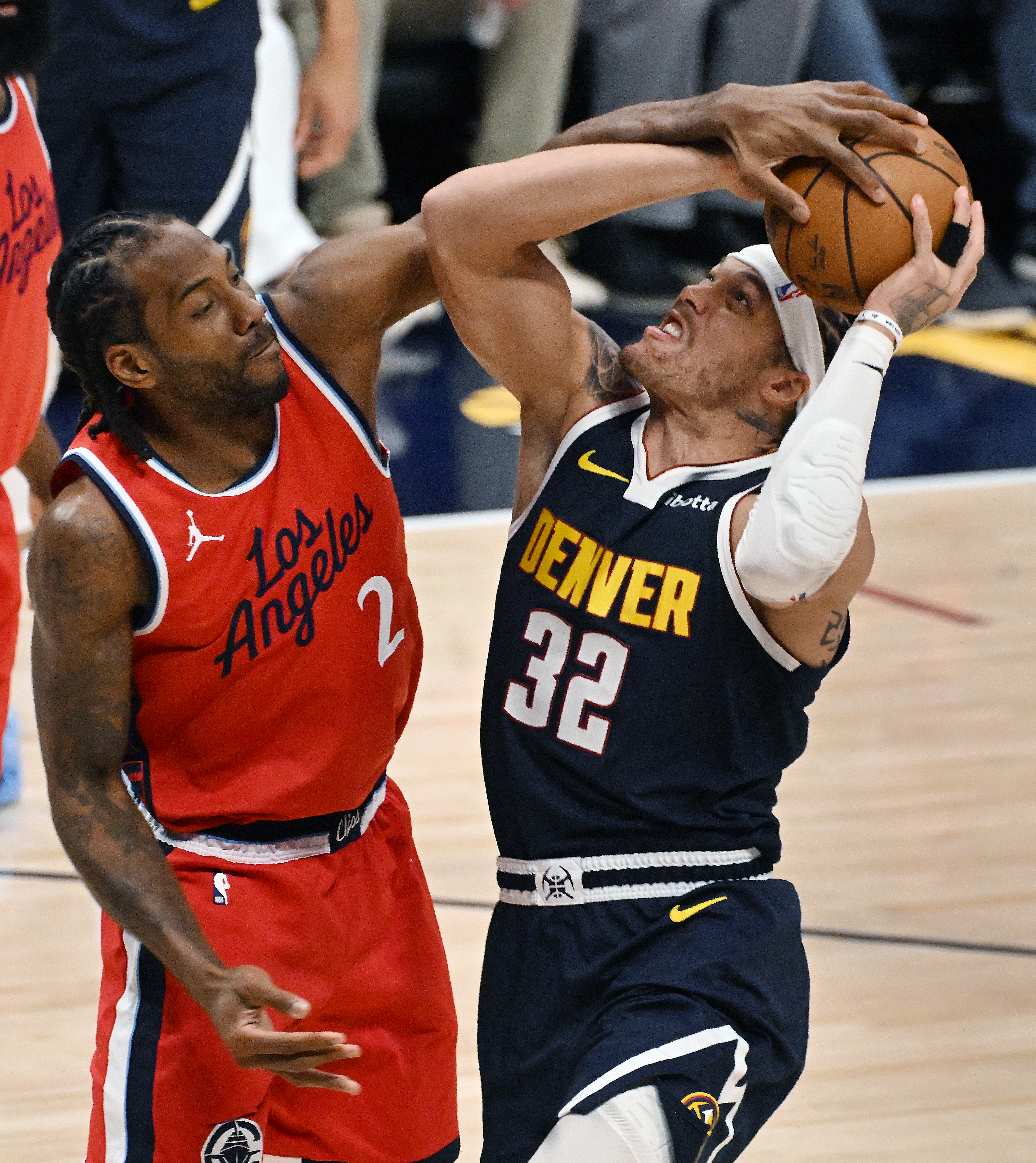 LA Clippers forward Kawhi Leonard (2) and Denver Nuggets forward Aaron Gordon (32) fight for the ball resulting in a jump ball during the 1st quarter of game 2 of Round 1 of the NBA Western Championship at Ball Arena on Monday, April 21, 2025. (Jerilee Bennett,The Gazette)