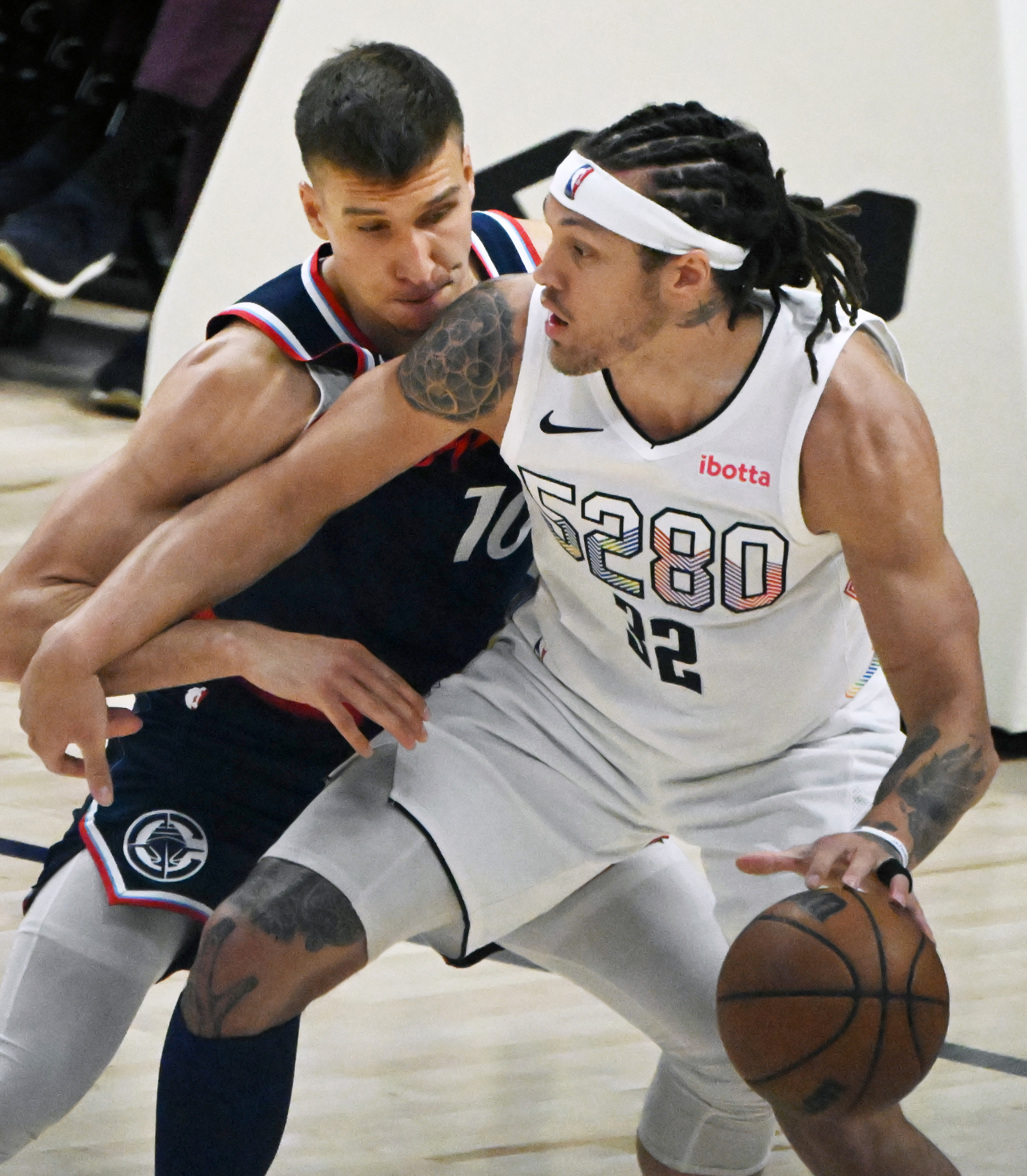 Denver Nuggets forward Aaron Gordon (32) is defended by LA Clippers guard Bogdan Bogdanovic (10) during game 5 of Round 1 against the Clippers on Tuesday, April 29, 2025. The Nuggets won the game 131-115. (Jerilee Bennett,The Gazette)
