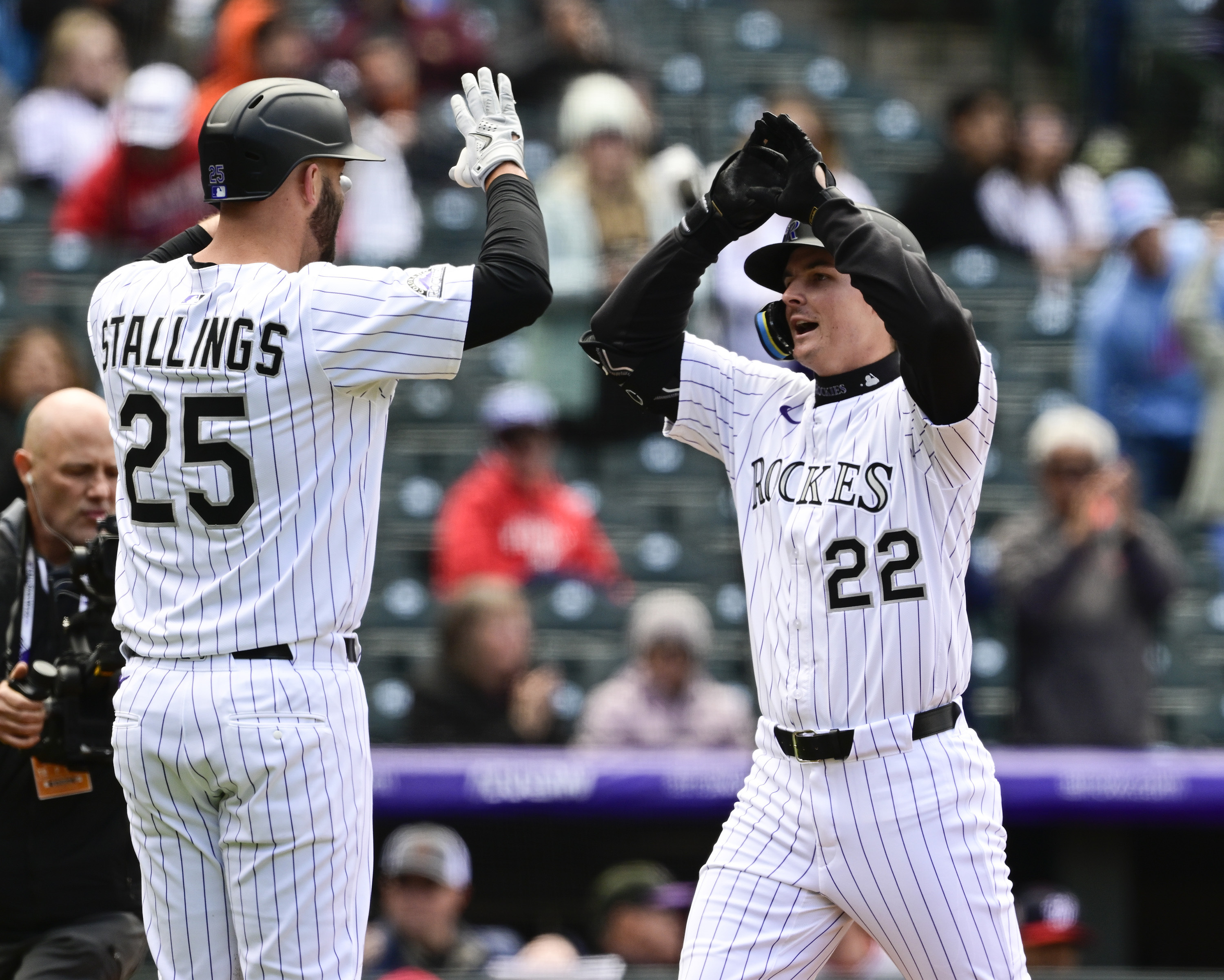 Colorado Rockies' Mickey Moniak, right, is congratulated as he crosses home plate by Jacon Stallings after hitting a two-run home run off Washington Nationals starting pitcher MacKenzie Gore in the second inning Saturday, April 19, 2025, in Denver. (via AP) (via The Associated Press)