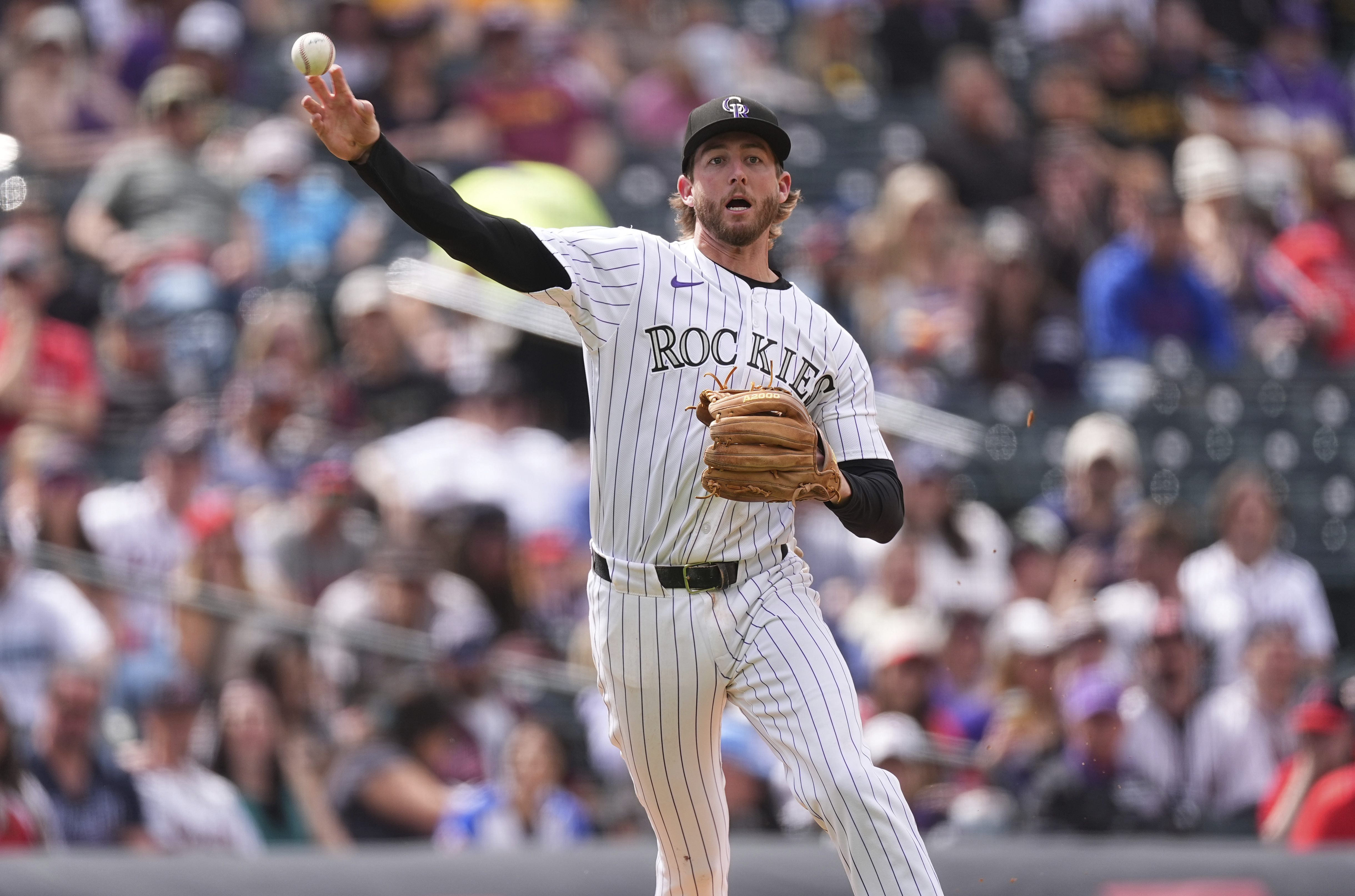 Colorado Rockies third baseman Ryan McMahon throws to first base Wednesday to put out Atlanta Braves' Marcell Ozuna in the ninth inning in Denver. (The Associated Press)