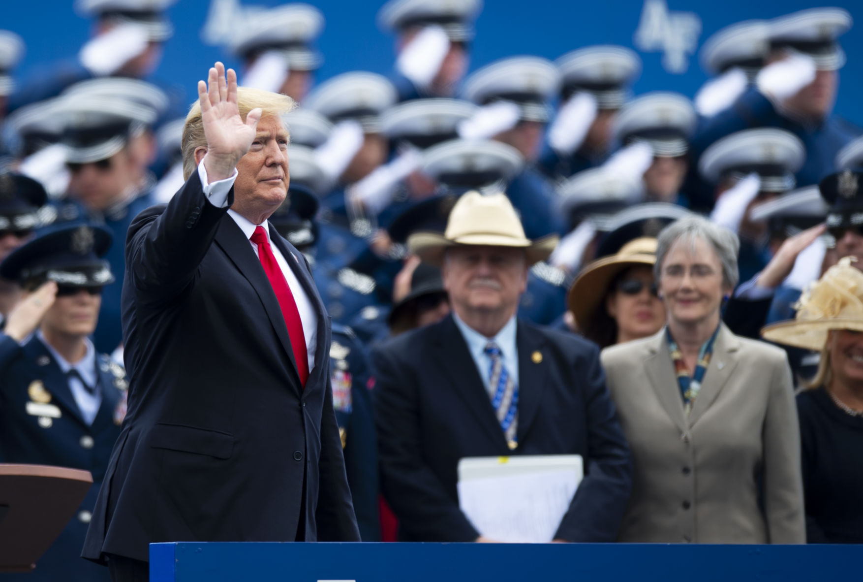 President Donald Trump waves to an excited crowd as he takes his seat on stage at the Air Force Academy graduation. (Parker Seibold)