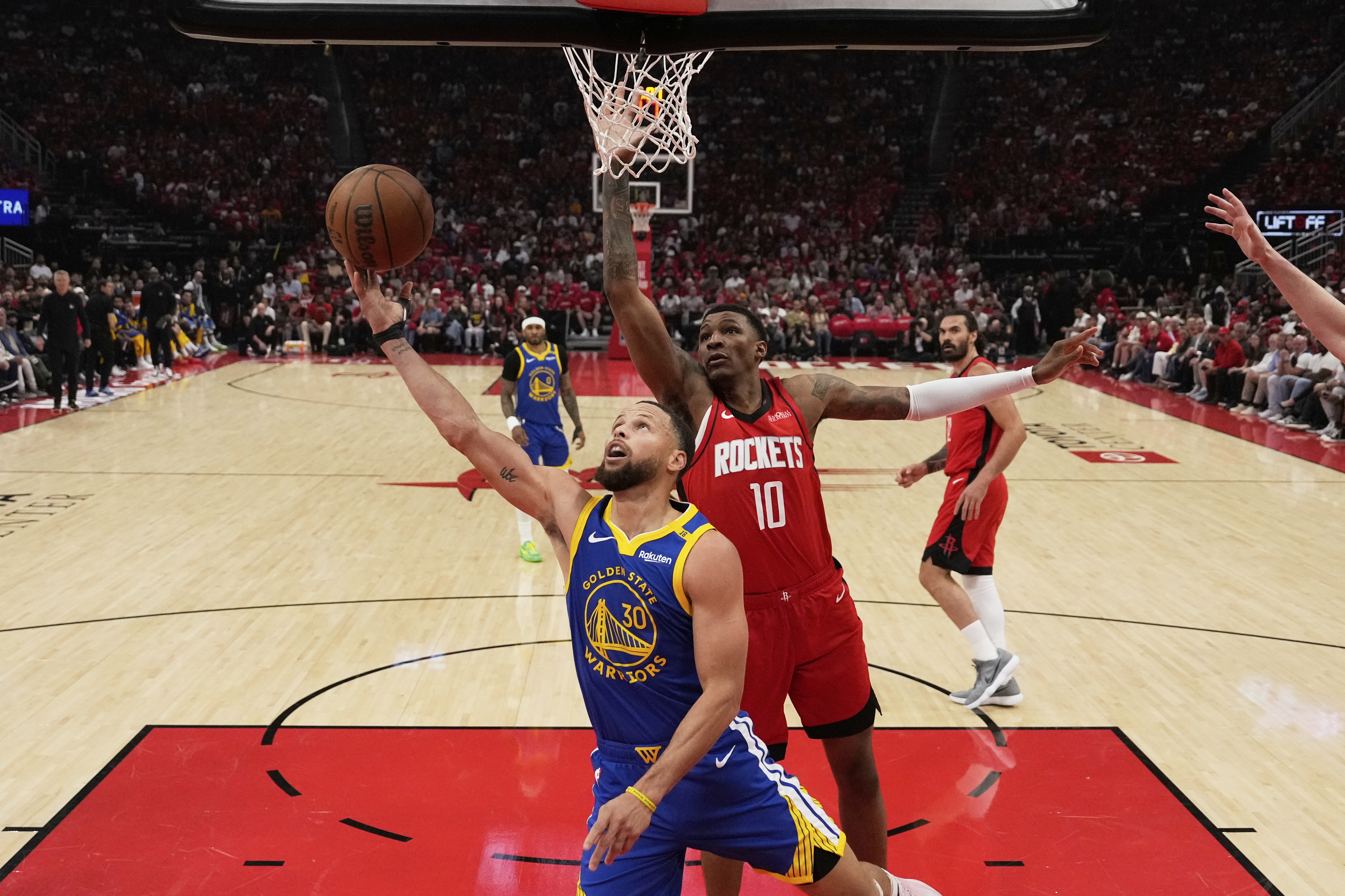 Golden State Warriors guard Stephen Curry (30) shoots against Houston Rockets forward Jabari Smith Jr. (10) during the first half of Game 1 of an NBA basketball first-round playoff series in Houston, Sunday, April 20, 2025. (AP Photo/Ashley Landis) (Ashley Landis)