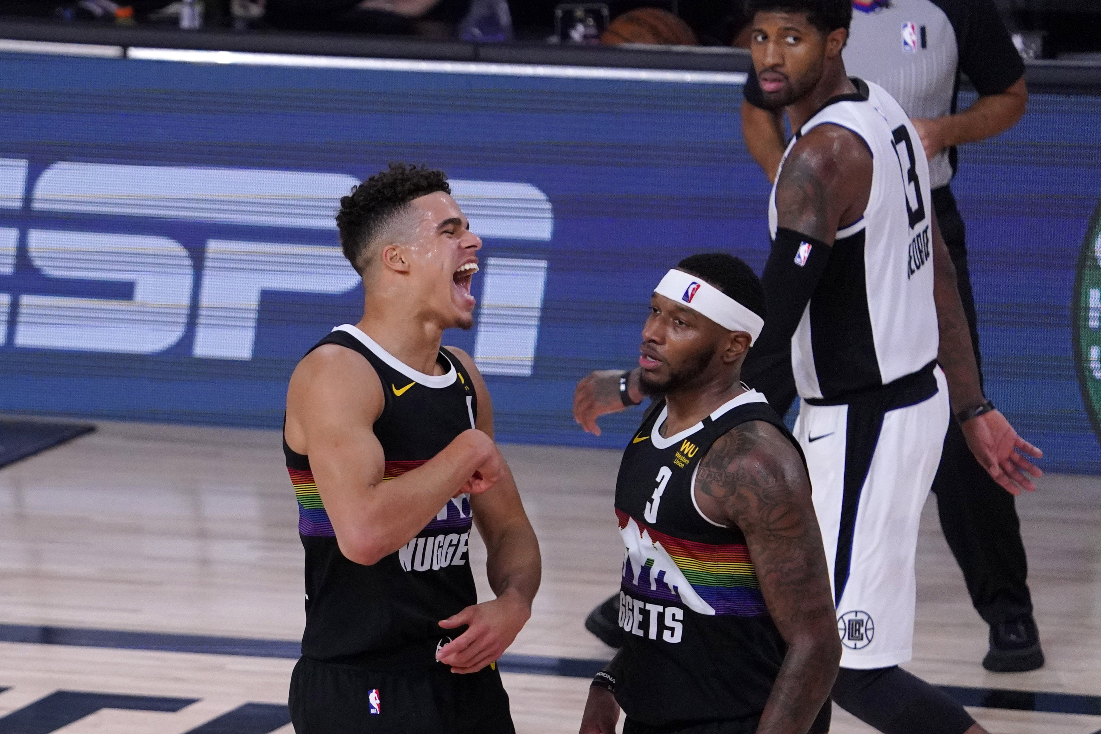 Denver Nuggets' Michael Porter Jr. (1) celebrates with Torrey Craig (3) during the second half of an NBA conference semifinal playoff basketball game against the Los Angeles Clippers Sunday, Sept. 13, 2020, in Lake Buena Vista, Fla. The Nuggets won 111-98. (AP Photo/Mark J. Terrill) (Mark J. Terrill)