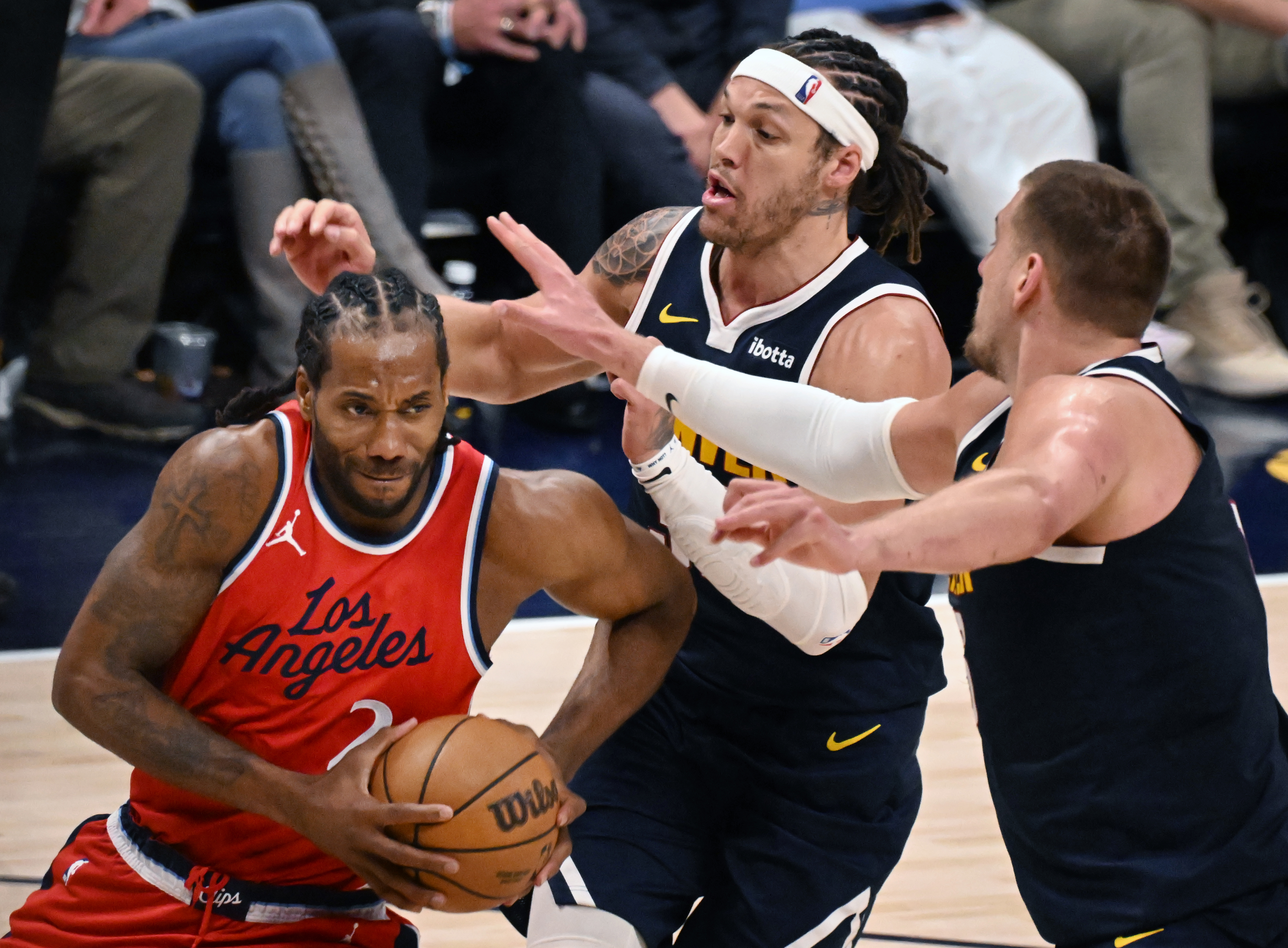 Denver Nuggets center Nikola Jokic (15) and Denver Nuggets forward Aaron Gordon (32) defend LA Clippers forward Kawhi Leonard (2) during the 4th quarter of game 2 of Round 1 of the NBA Western Championship at Ball Arena on Monday, April 21, 2025. (Jerilee Bennett,The Gazette)