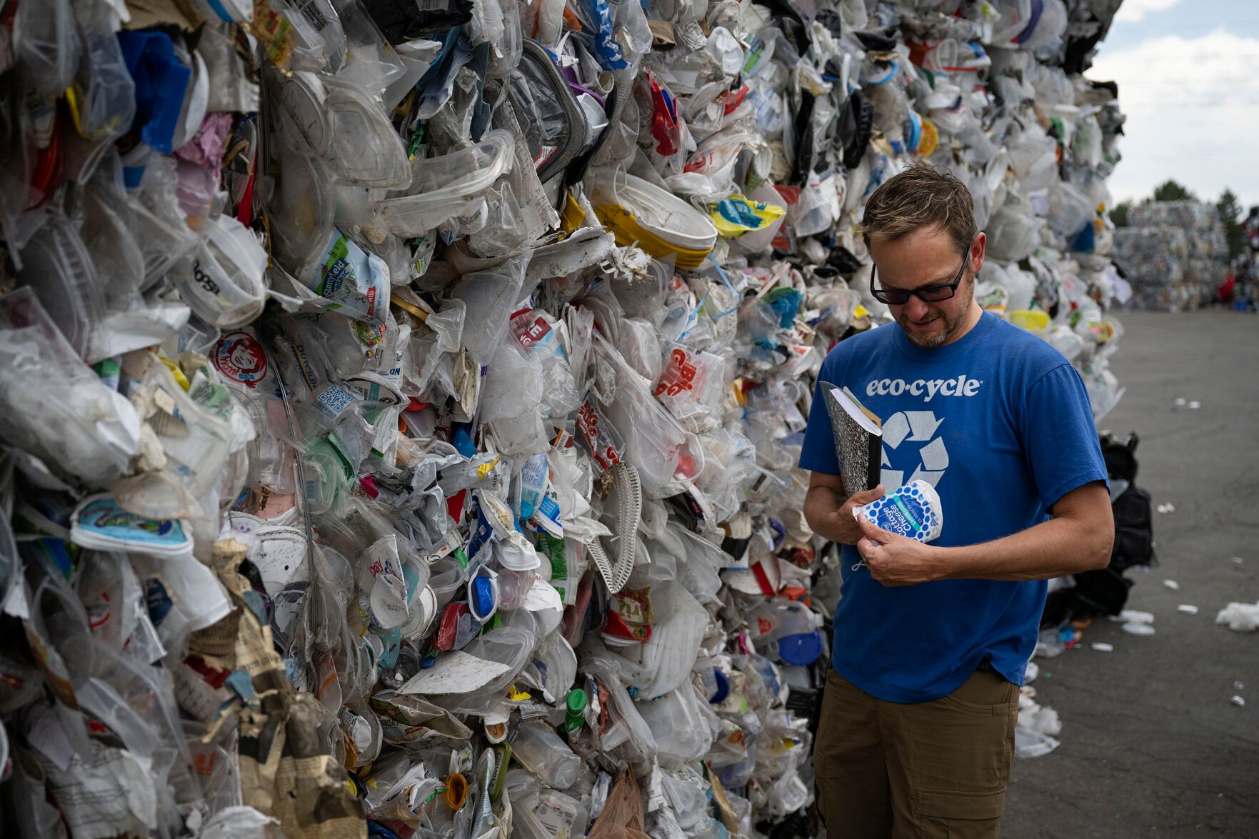 Eco-Cycle legislature and community campaign director Randy Moorman looks for the recycling symbol number on a food container pulled from bales that are ready to ship on Tuesday, July 19, 2022, at the Boulder County Recycling Center in Boulder, Colo. (Timothy Hurst/The Denver Gazette) (Timothy Hurst)