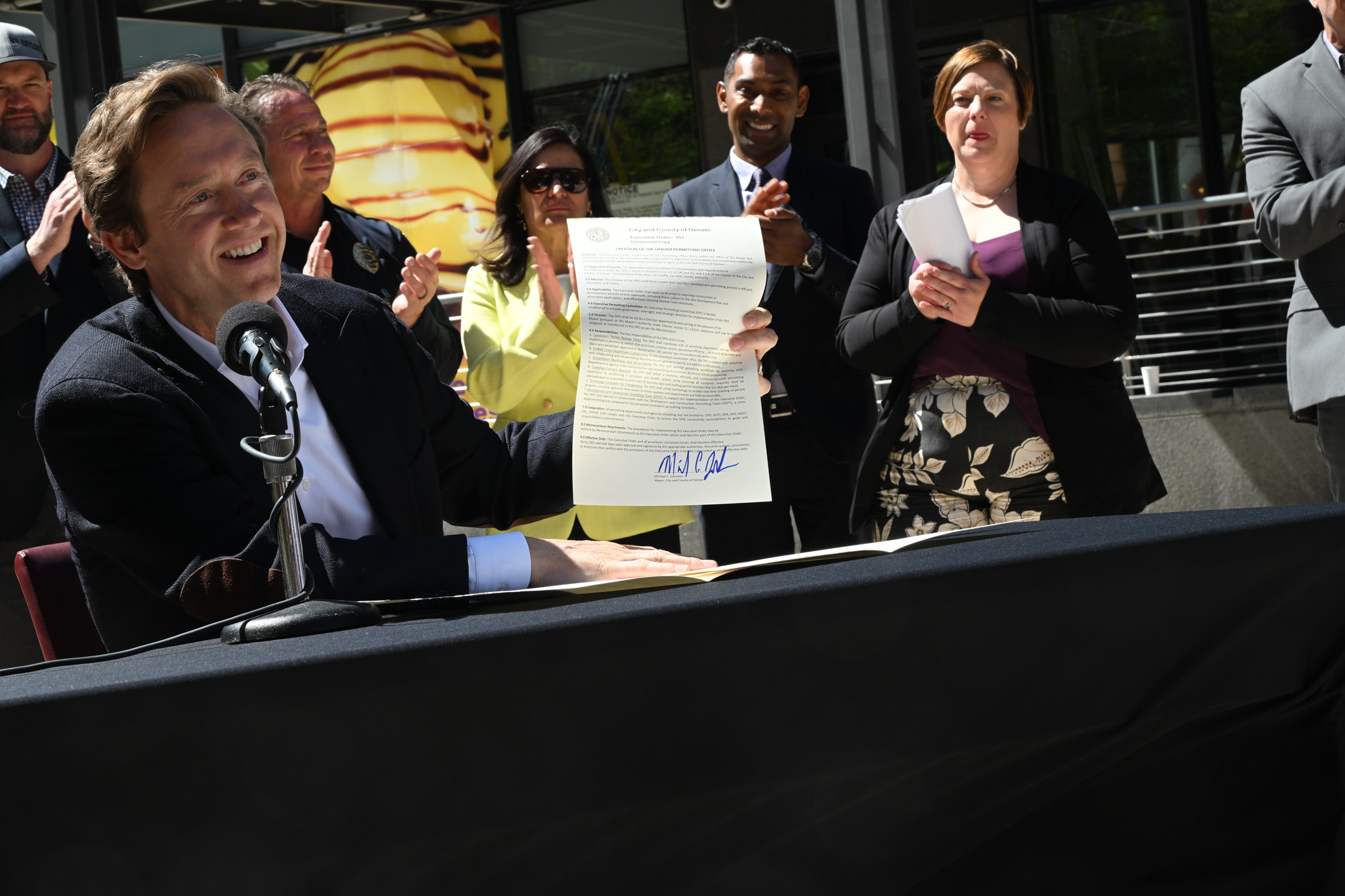 Denver Mayor Mike Johnston holds up a freshly signed executive order on April 14 creating the Denver Permitting Office or DPO. The new office promises to streamline the permitting process and will hold the city accountable to deliver faster and more efficient service to those looking to build housing or open businesses in the city. This is the first executive order of Johnston's administration. (Deborah Grigsby/The Denver Gazette) (Deborah Grigsby)