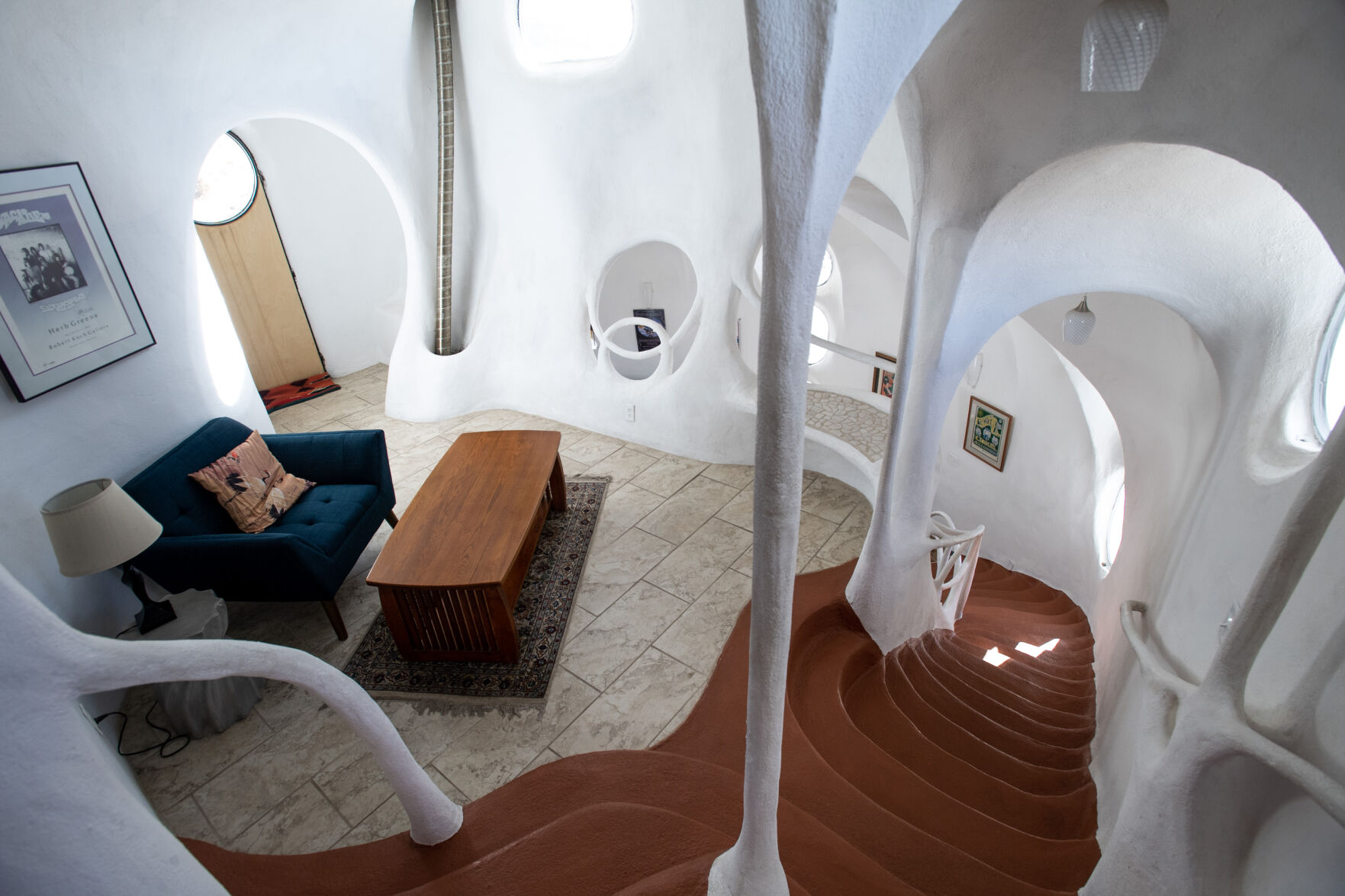 ABOVE: Inside the Crestone Hobbitat, visitors will find no corners. From the archways on the ceilings, to the build in shelving on the walls to the stairs, every feature is made with round, fluid-feeling edges. “Living in the round takes away the edges,” owner Jeff Beard says. (photos by Parker Seibold, The Gazette)