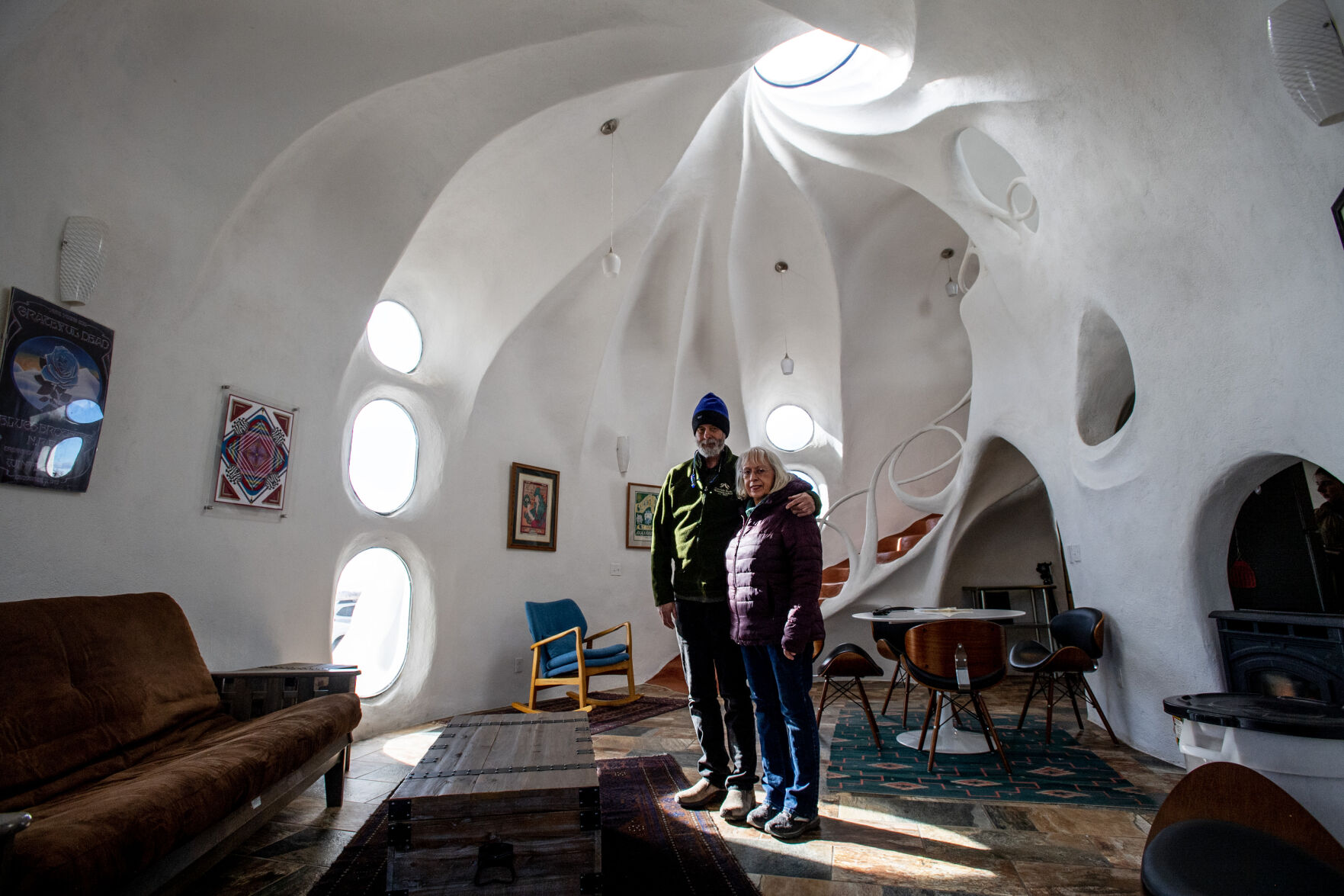 Husband and wife Jeff and Ruth Beard pose for a portrait inside the Crestone Hobbitat last month in Crestone. The house, which is 17 years in the making, started as a studio for Jeff in 2008 but has become a popular Airbnb rental. (Photos by Parker Seibold, The Gazette)