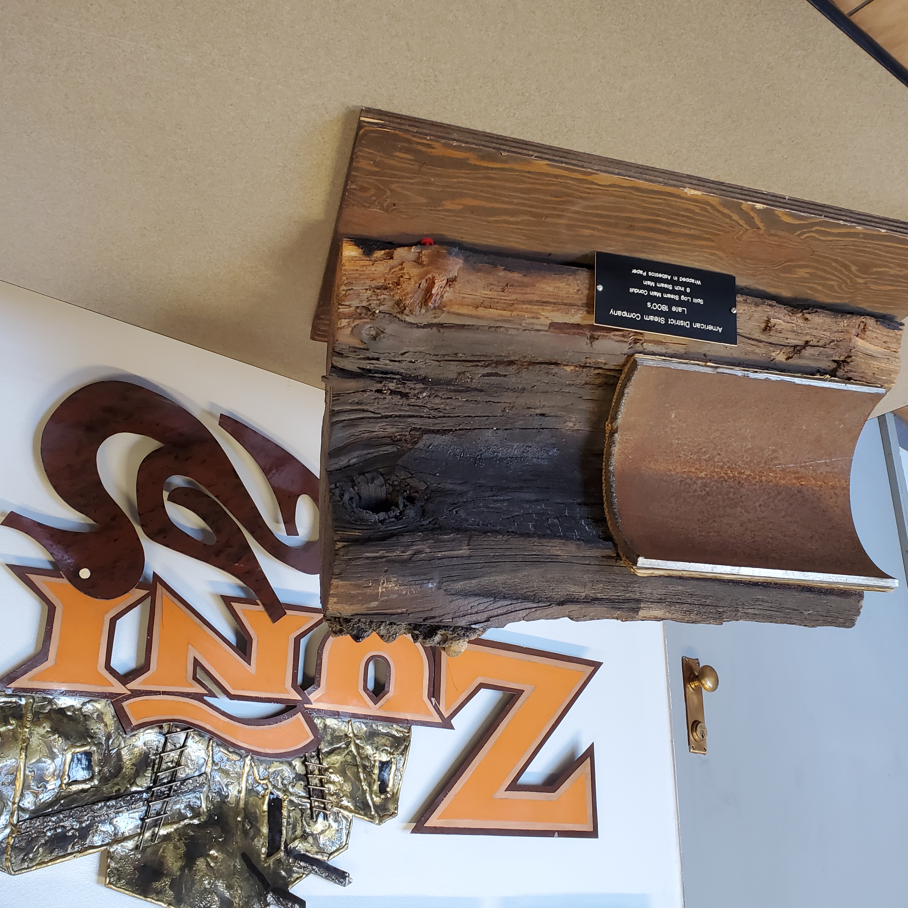Cutaway section of original 1880 8-inch steam pipe from Denver steam system. The steel pipe is wrapped in asbestos and insulated by a hollowed-out log. (Courtesy Xcel Energy/Michelle Aguayo)