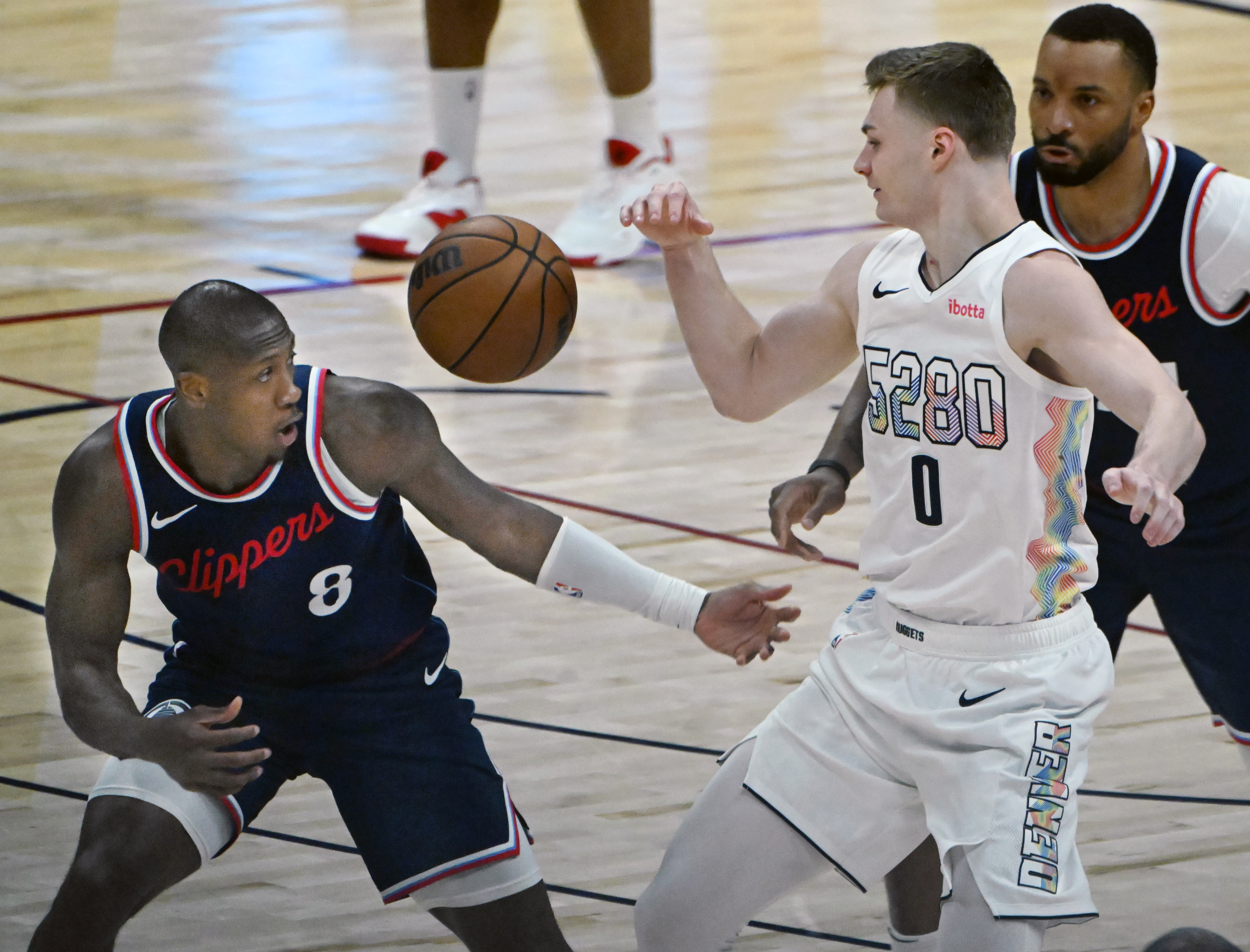 LA Clippers guard Kris Dunn (8) and Denver Nuggets guard Christian Braun (0) go after a loose ball during the 4th quarter of game 5 of the first round of the Western Championships at Ball Arena on Tuesday, April 29, 2025. (Jerilee Bennett,The Gazette)