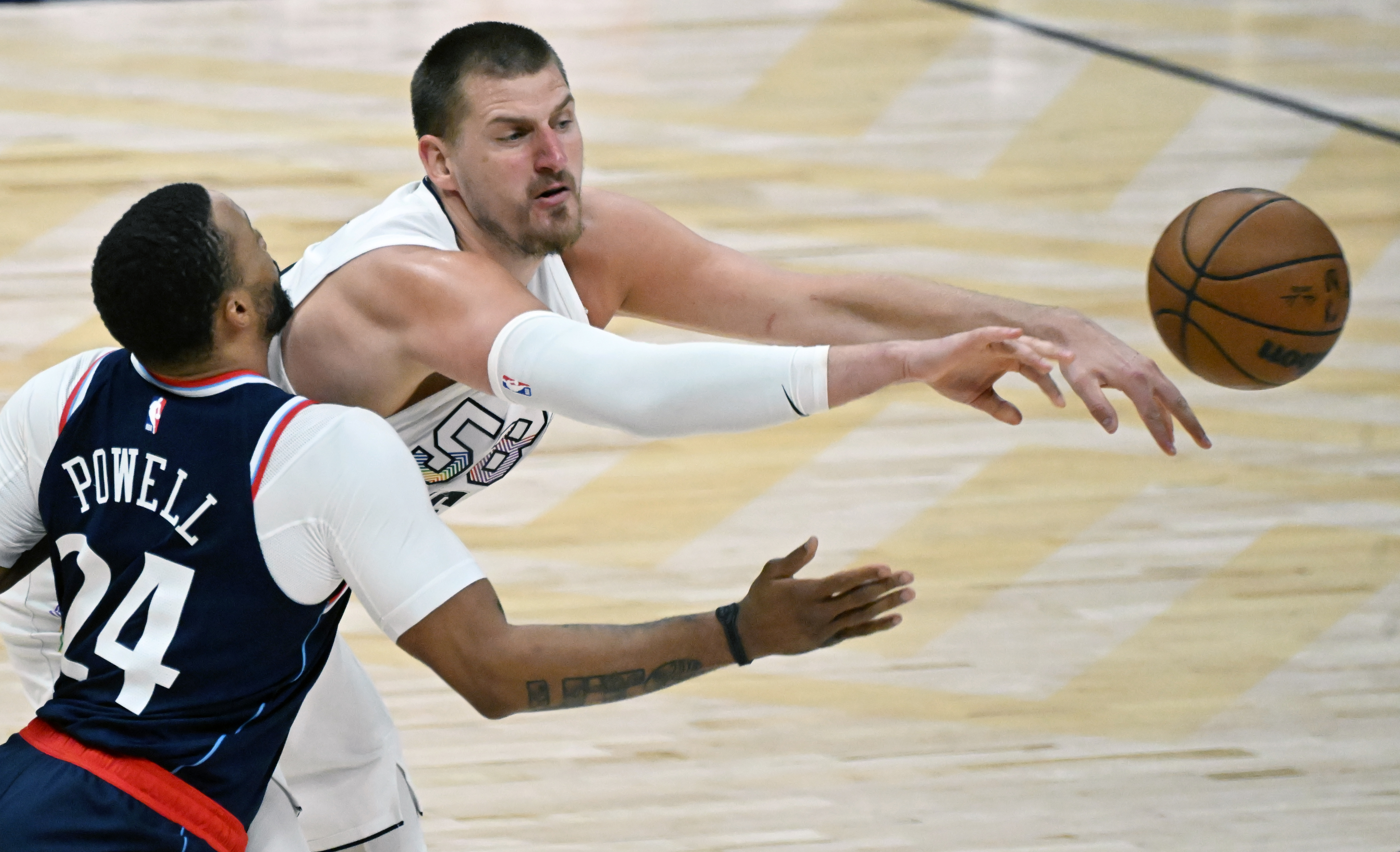 Denver Nuggets center Nikola Jokic (15) passes the ball past LA Clippers guard Norman Powell (24) during game 5 of Round 1 against the Clippers on Tuesday, April 29, 2025. The Nuggets won the game 131-115. (Jerilee Bennett,The Gazette)