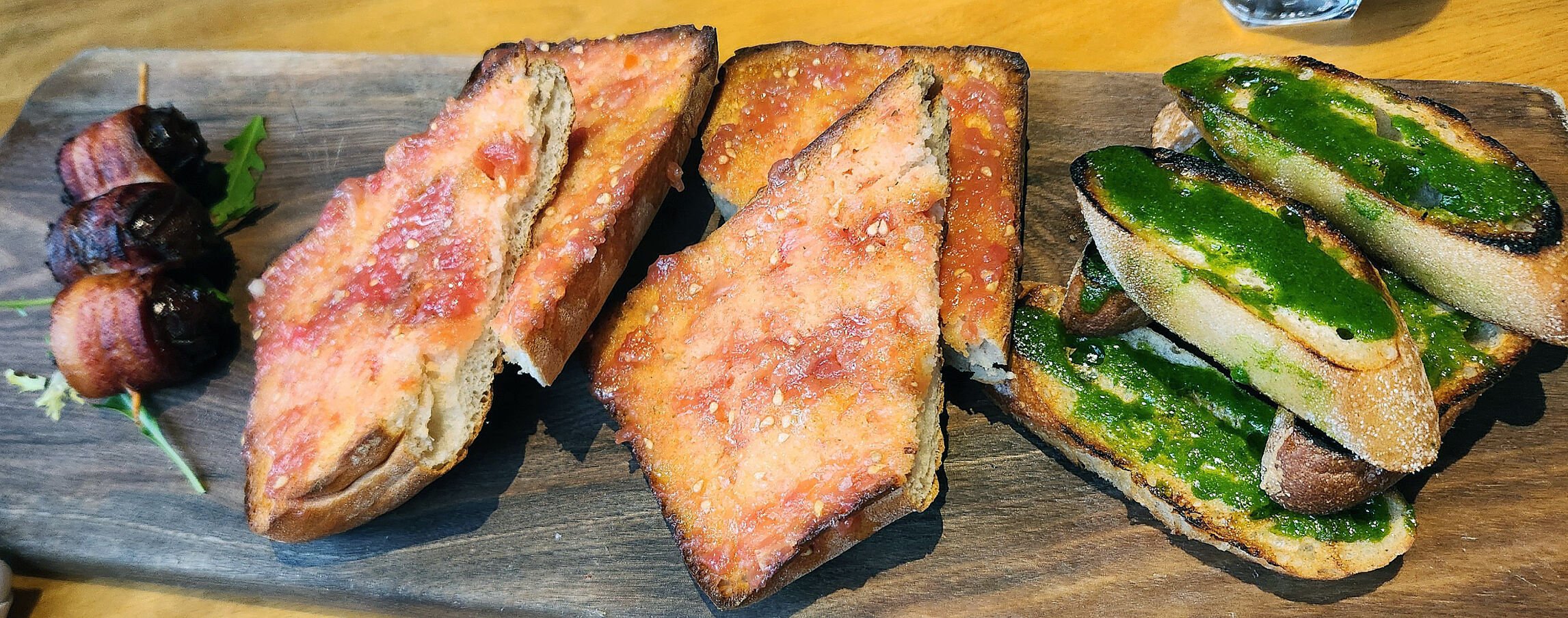 Two types of toasted bread and Datiles, bacon-wrapped dates stuffed with almonds and blue cheese at The 9th Door in Denver. Robin Intemann/ The Gazette