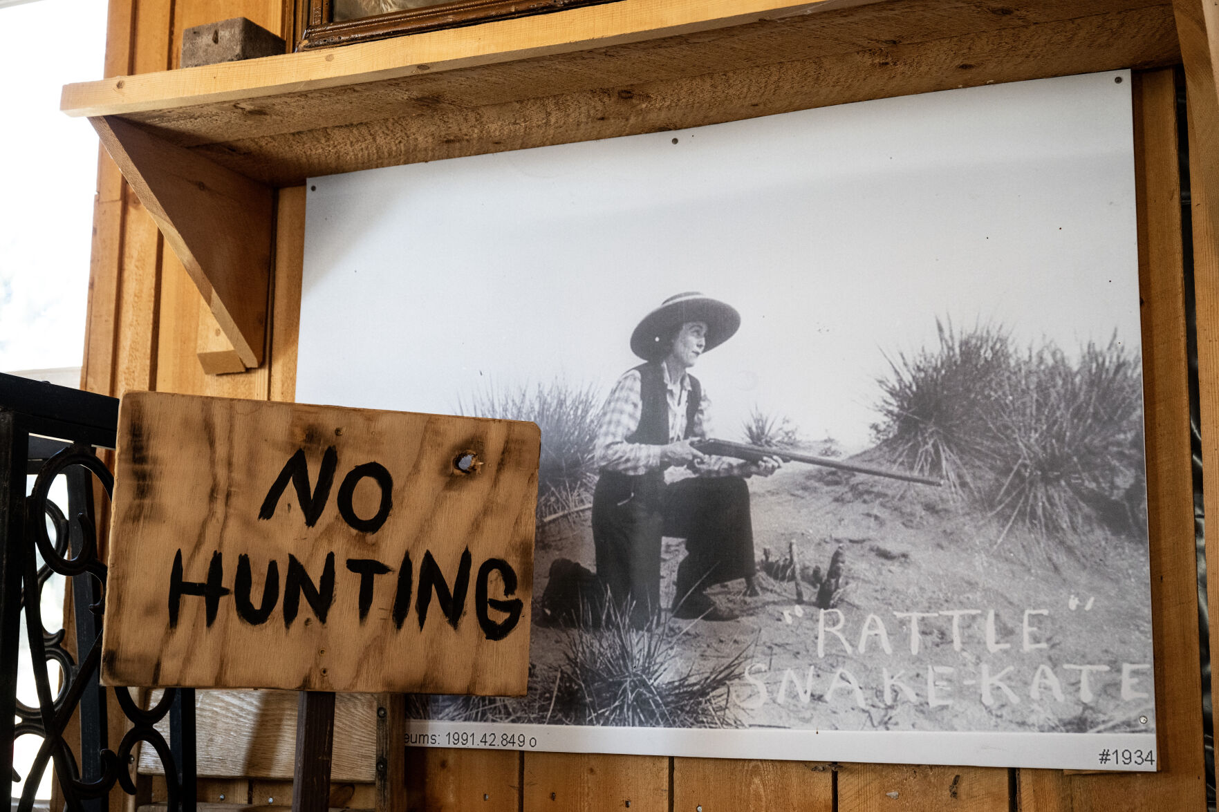 An image of Rattlesnake Kate with her .22 Remington rifle that claimed her first slithering victims is on display next to a “NO HUNTING” signpost on Tuesday, Feb. 25, 2025, in Greeley, Colo. (Parker Seibold, The Gazette) (Parker Seibold)