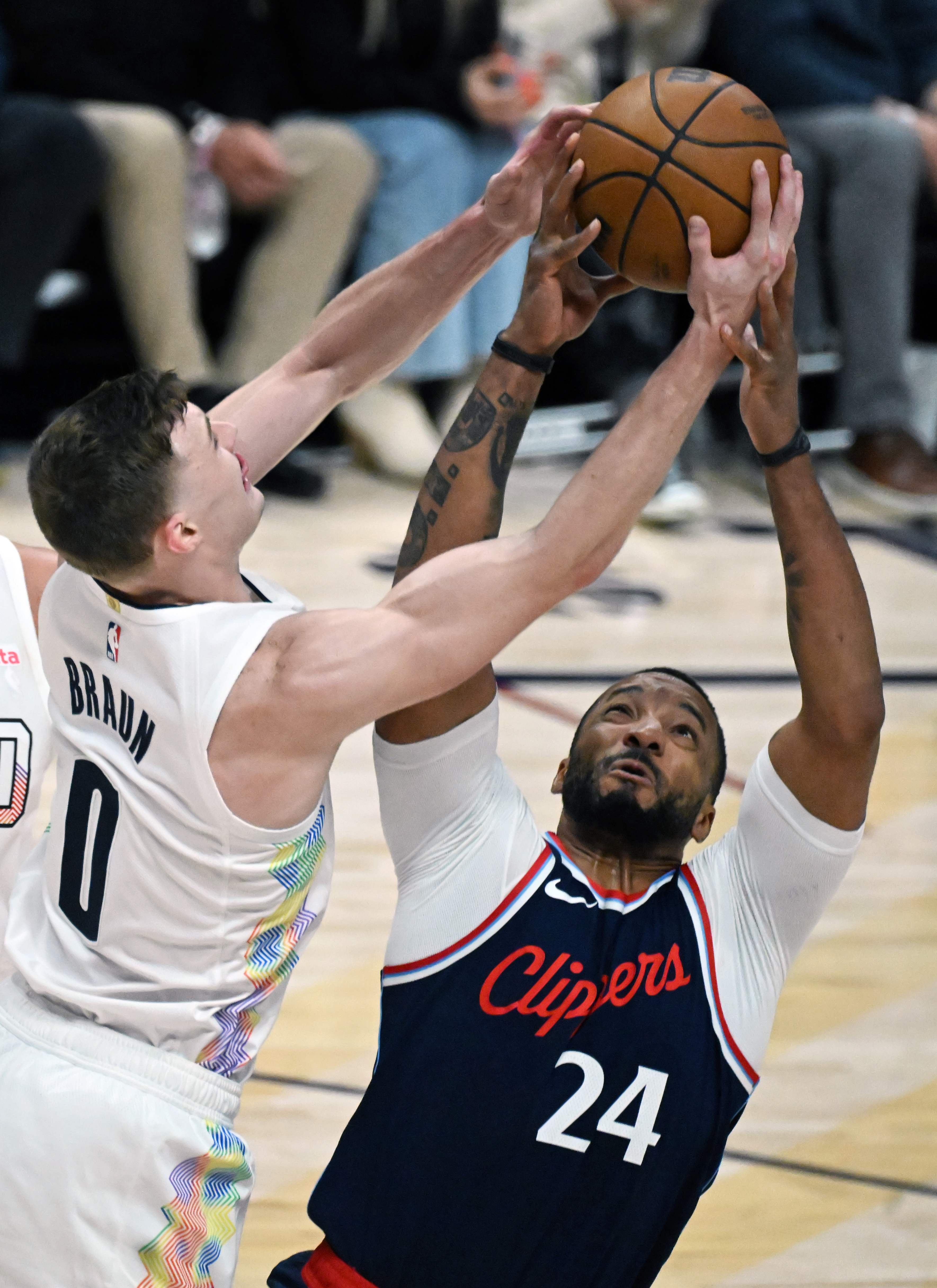 Denver Nuggets guard Christian Braun (0) fights LA Clippers guard Norman Powell (24) for a defensive rebound during game 5 of Round 1 against the Clippers on Tuesday, April 29, 2025. The Nuggets won the game 131-115. (Jerilee Bennett,The Gazette)