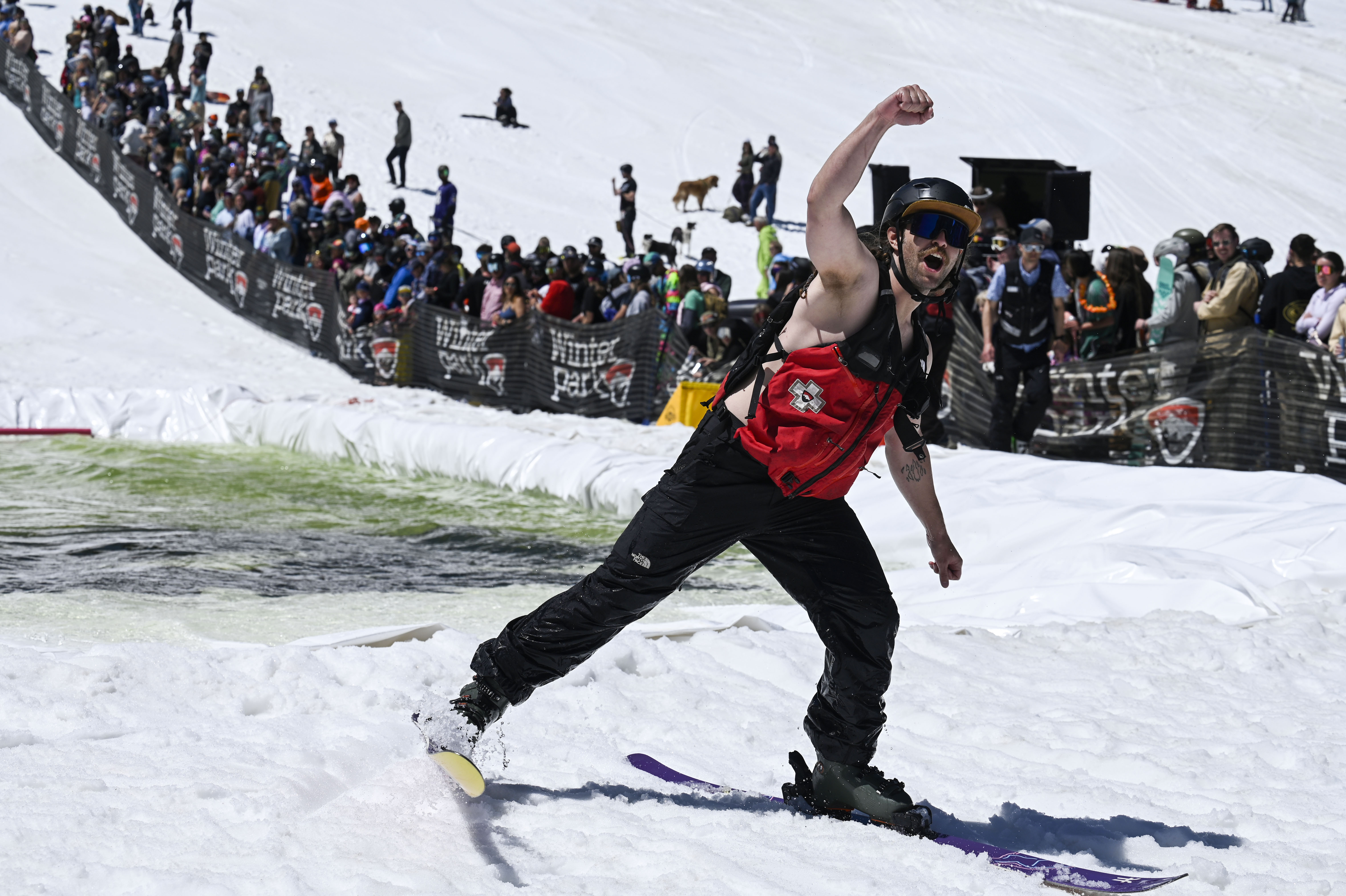 A competitor cheers after successfully skiing across a pool of water at the base of Winter Park during the Spring Splash event to celebrate the last day of the season on Sunday, April 27, 2025 (Stephen Swofford, Denver Gazette) (StephenSwoffordPhotographerstephen.swofford@gazette.comhttps://secure.gravatar.com/avatar/1ddcaf11c5d70eaa58546ddc4e038687?d=mm&r=g)