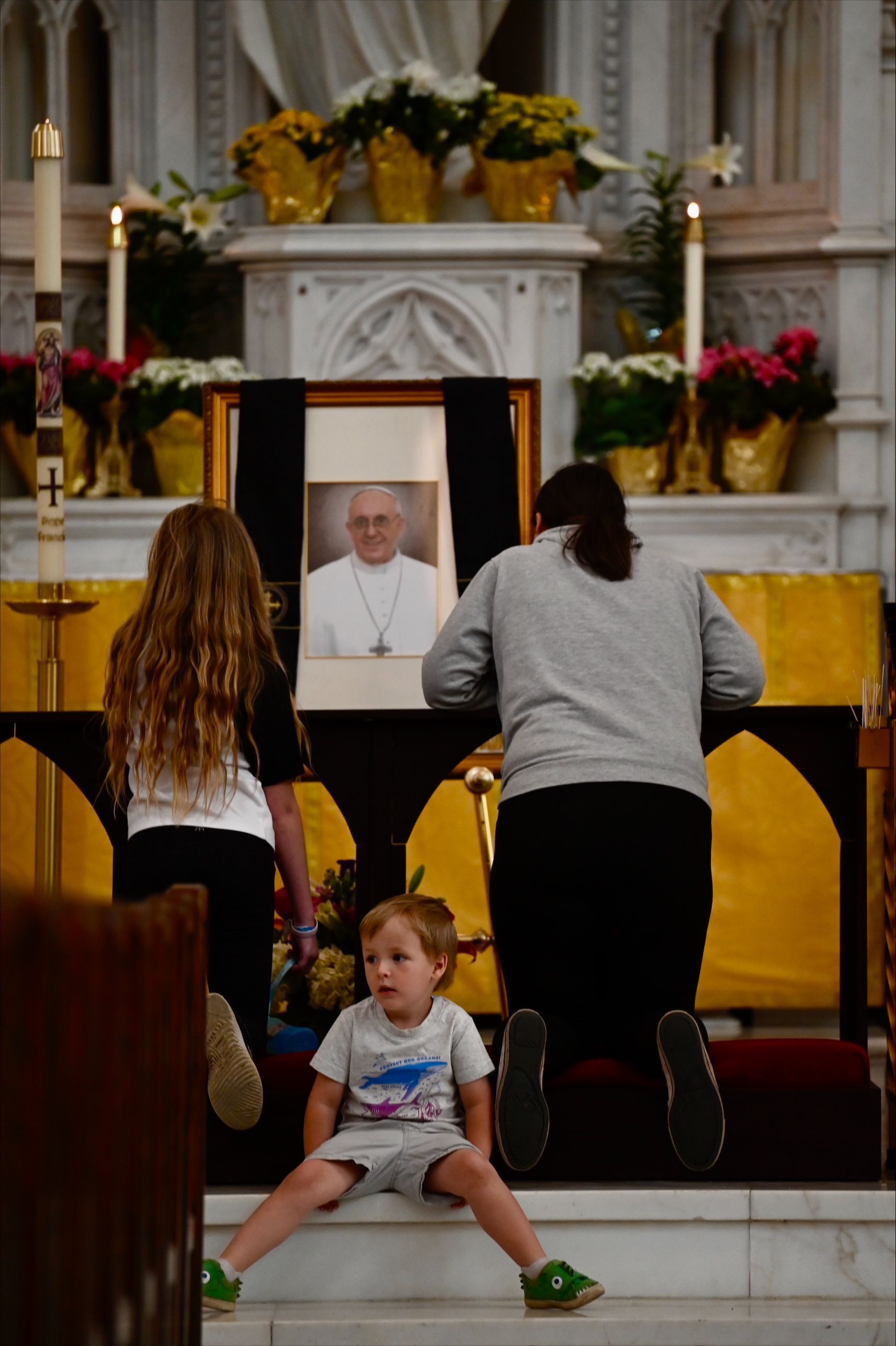 Mae Worthington (left), 10, her brother Hank, 3, and her mother Katy (right) pray for the late Pope Francis, who died Monday morning at 88, at the Cathedral Basilica of the Immaculate Conception in downtown Denver. (StephenSwoffordPhotographerstephen.swofford@gazette.comhttps://secure.gravatar.com/avatar/1ddcaf11c5d70eaa58546ddc4e038687?d=mm&r=g)