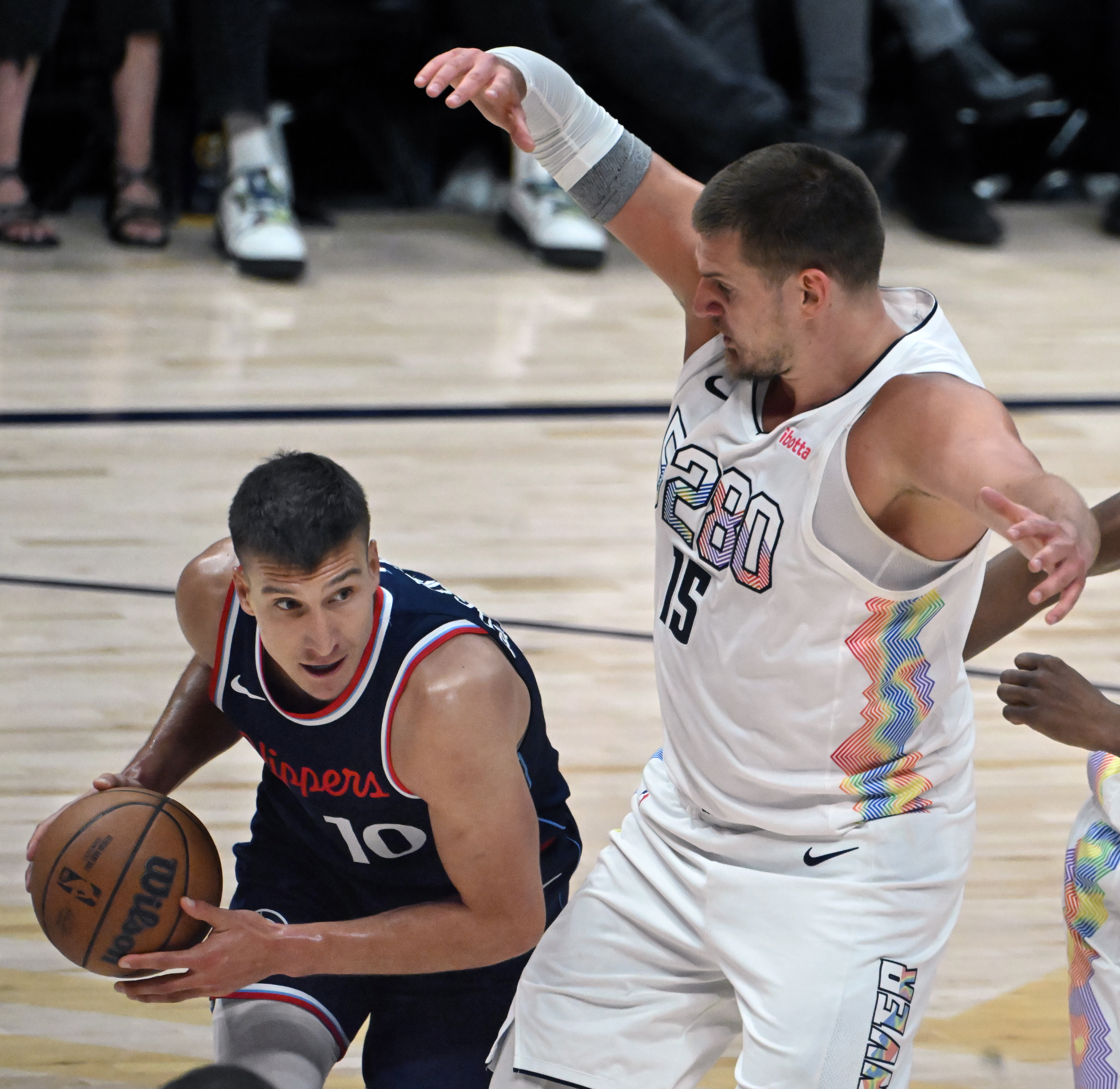 LA Clippers guard Bogdan Bogdanovic (10) is pressured by Denver Nuggets center Nikola Jokic (15) causing him to travel during the 3rd quarter of game 5 of the first round of the Western Championships at Ball Arena on Tuesday, April 29, 2025. (Jerilee Bennett,The Gazette)