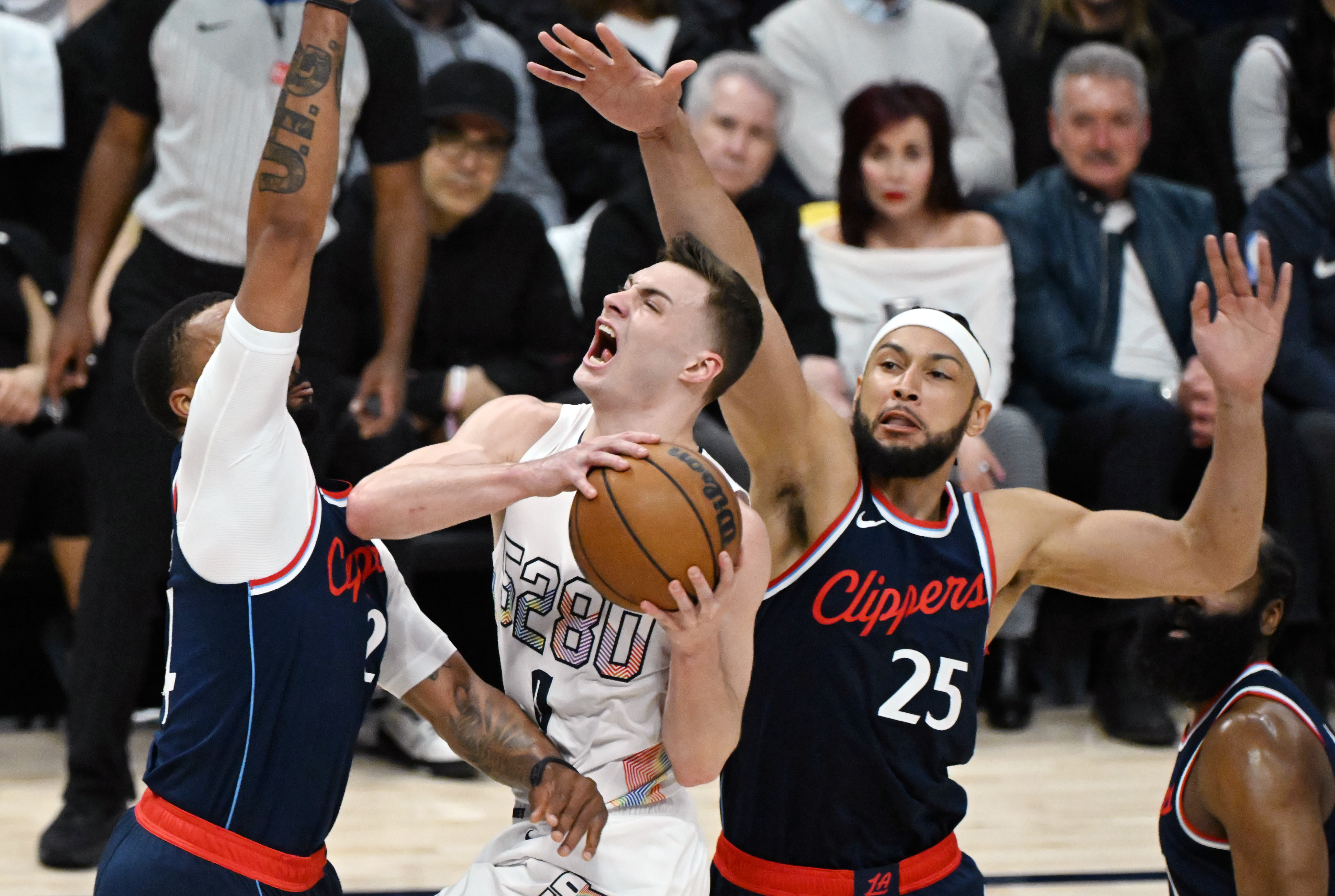 Denver Nuggets guard Christian Braun (0) shoots the ball while being defended by LA Clippers guard Norman Powell (24) (left) and LA Clippers guard Ben Simmons (25) during the 1st quarter of game 5 of the first round of the Western Championships at Ball Arena on Tuesday, April 29, 2025. (Jerilee Bennett,The Gazette)