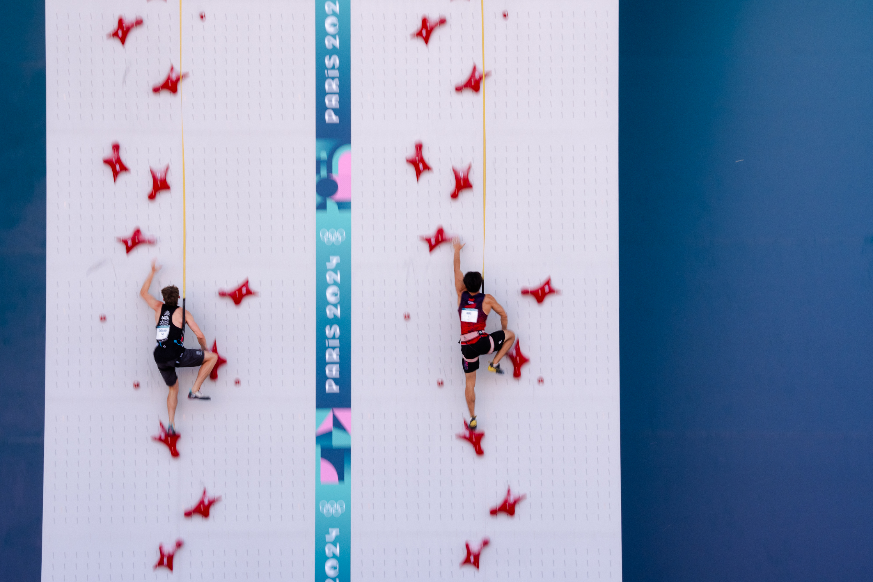 Two male speed climbers compete during a Speed Climbing event at the Olympic Games in Paris in August 2024. (Courtesy, IFSC)
