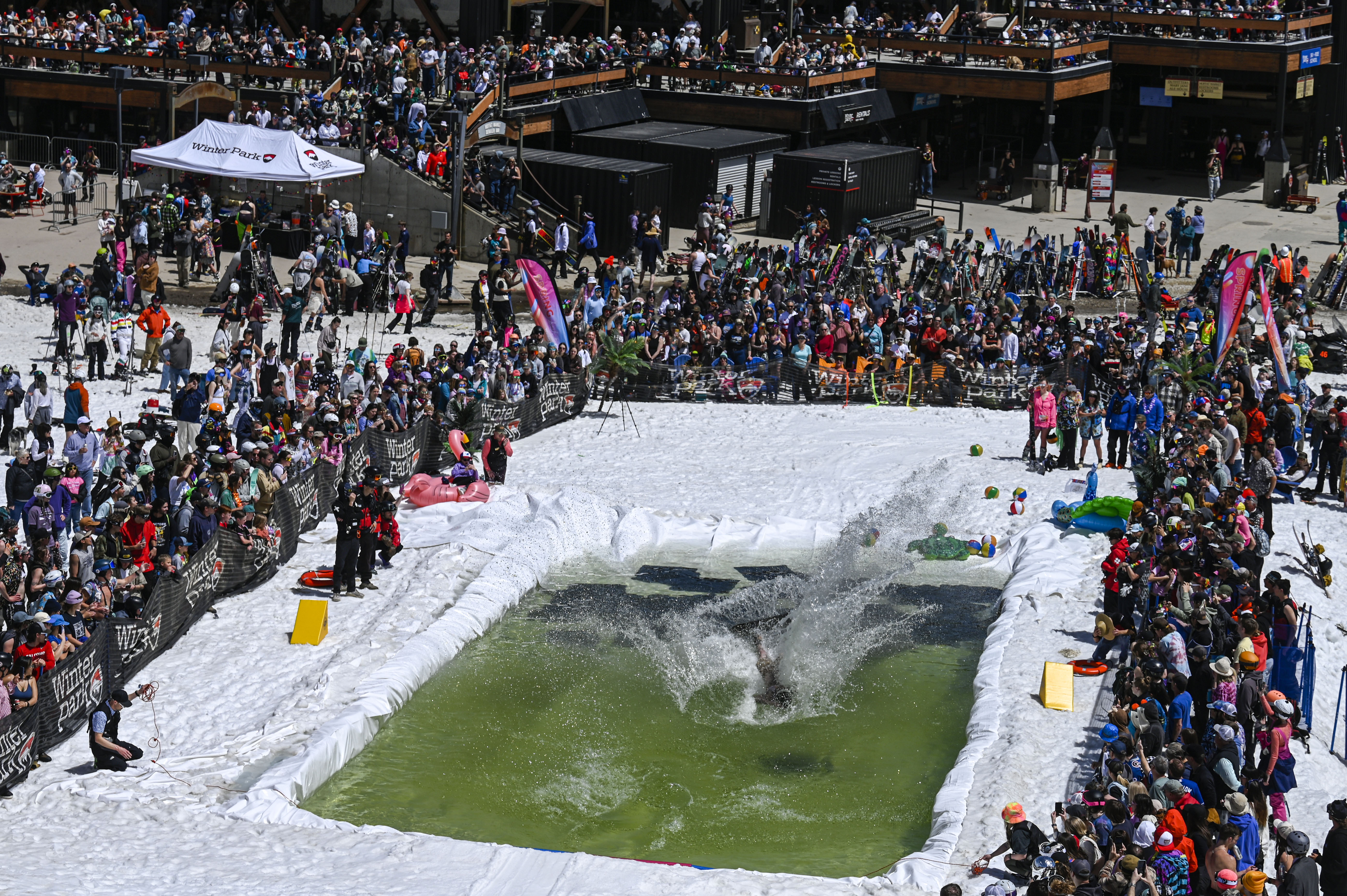 A crowd watches competitors attempt to ski and snowboard across a pool of water at the base of Winter Park during the Spring Splash event to celebrate the last day of the season on Sunday, April 27, 2025 (Stephen Swofford, Denver Gazette) (StephenSwoffordPhotographerstephen.swofford@gazette.comhttps://secure.gravatar.com/avatar/1ddcaf11c5d70eaa58546ddc4e038687?d=mm&r=g)
