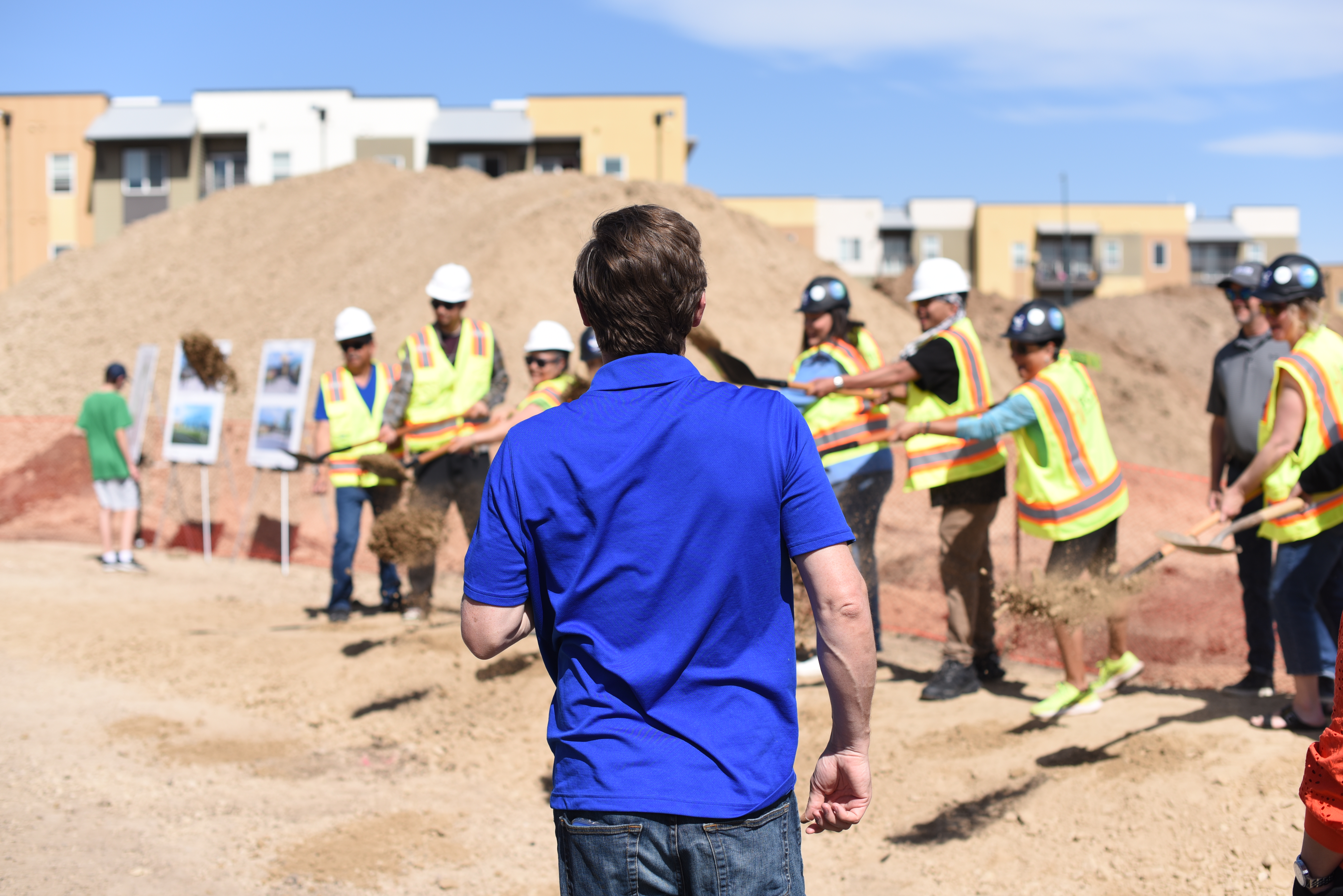 Denver Mayor Mike Johnston watches as Westwood community members and others involved in the recreation center project participate in a ceremonial dirt toss at the April 12 breaking ground event. (Michael Braithwaite / The Denver Gazette) (Michael Braithwaite / The Denver Gazette)