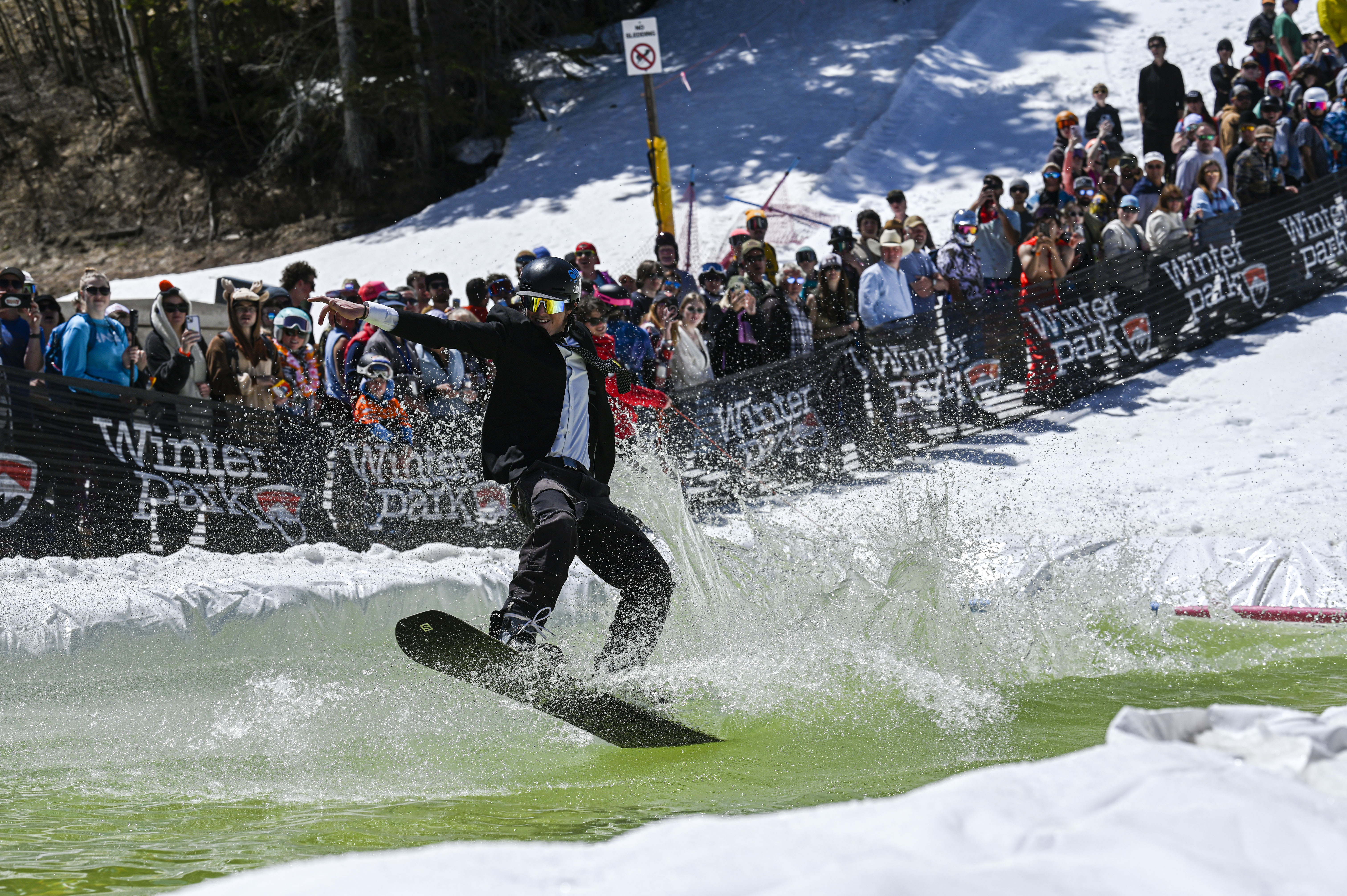 A competitor snowboards across a pool of water at the base of Winter Park during the Spring Splash event to celebrate the last day of the season on Sunday, April 27, 2025 (Stephen Swofford, Denver Gazette) (StephenSwoffordPhotographerstephen.swofford@gazette.comhttps://secure.gravatar.com/avatar/1ddcaf11c5d70eaa58546ddc4e038687?d=mm&r=g)