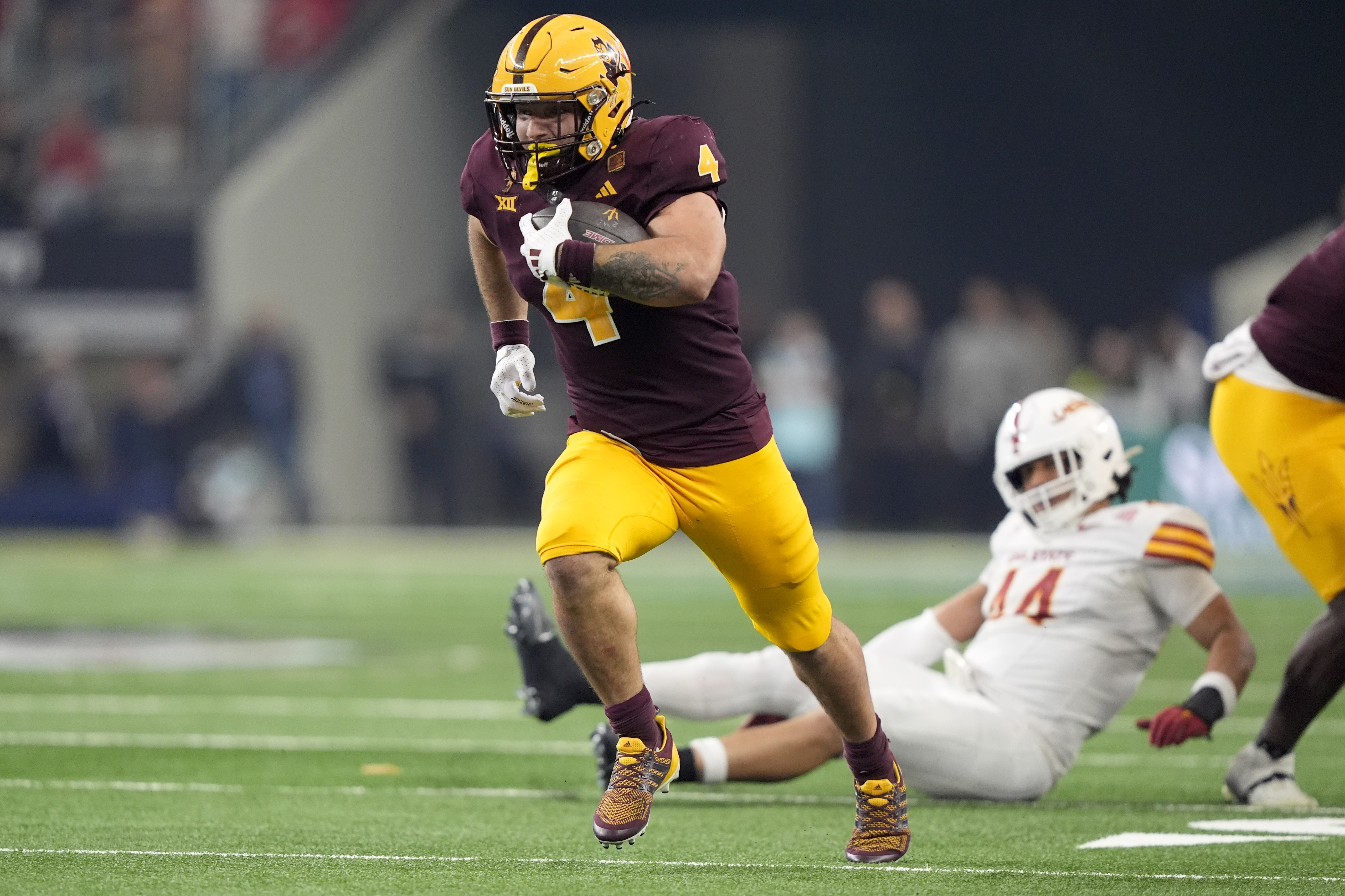 Arizona State running back Cam Skattebo (4) sprints to the end zone for a touchdown in the second half of the Big 12 Conference championship NCAA college football game against Iowa State, in Arlington, Texas, Saturday Dec. 7, 2024. (AP Photo/LM Otero) (LM Otero)
