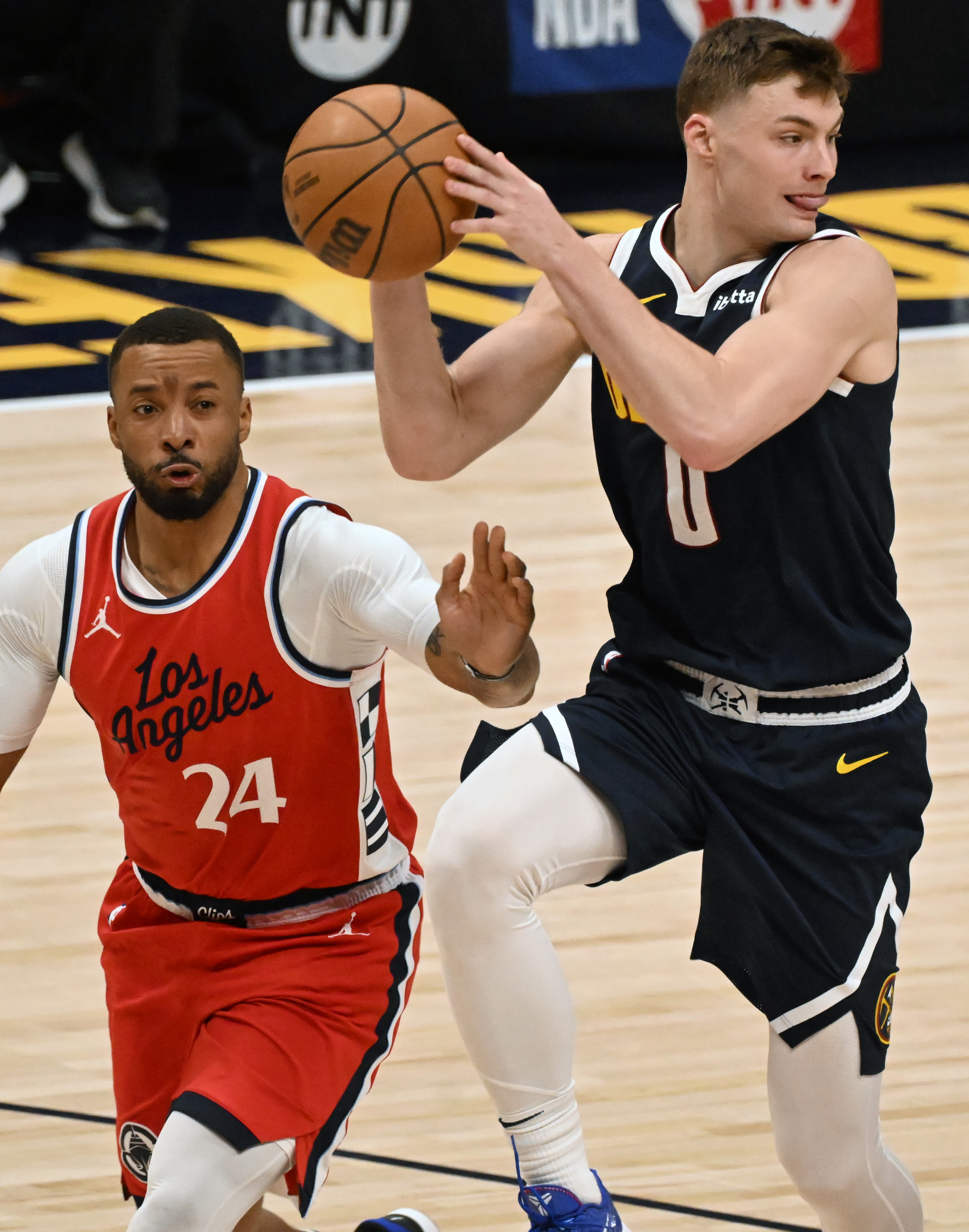 Denver Nuggets guard Christian Braun (0) goes up to pass the pass while being defended by LA Clippers guard Norman Powell (24) during 2nd quarter of game 2 of Round 1 of the NBA Western Championship at Ball Arena on Monday, April 21, 2025. (Jerilee Bennett,The Gazette)
