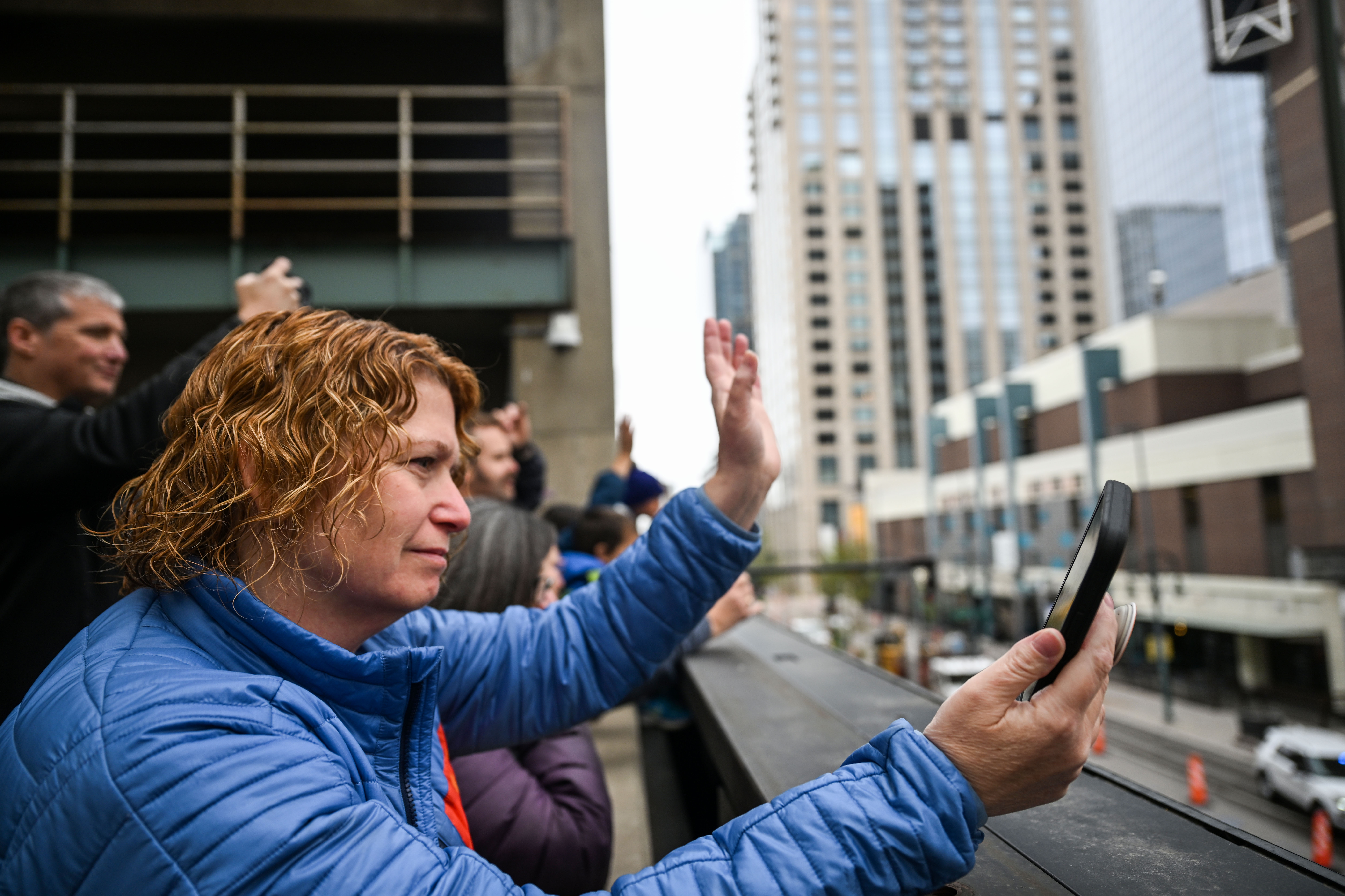 Kerri Marshen waves to her son, Kellen Arnold, from a parking structure as 5,000 students of all ages from Denver Public Schools march from Skyline park to the Denver Center for Performing Arts during the opening parade to kick off the 41st Annual DPS Shakespeare Festival on Friday, April 25, 2025. The festival is the oldest and largest student Shakespeare festival in the country. (Stephen Swofford, Denver Gazette) (StephenSwoffordPhotographerstephen.swofford@gazette.comhttps://secure.gravatar.com/avatar/1ddcaf11c5d70eaa58546ddc4e038687?d=mm&r=g)