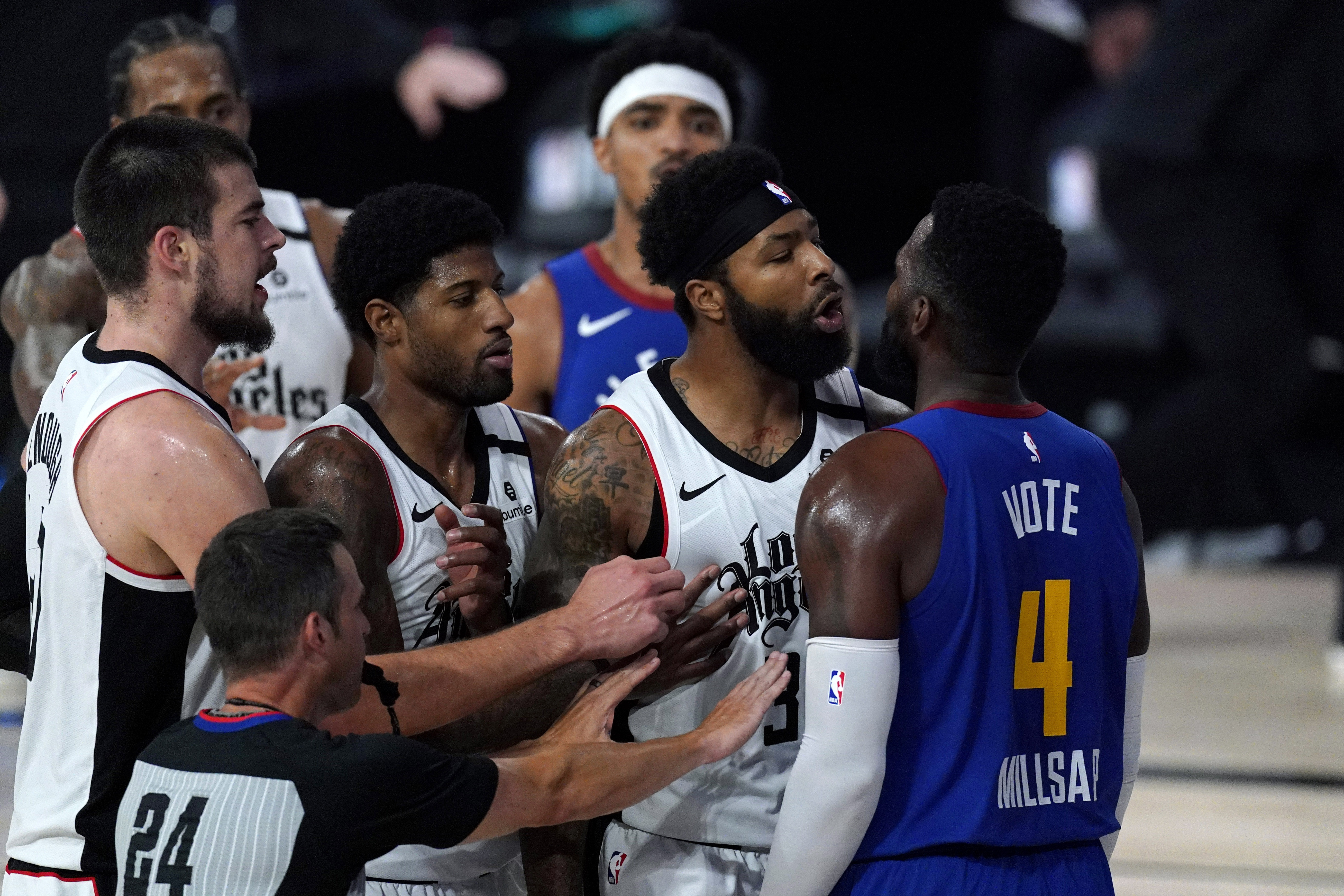 Los Angeles Clippers' Marcus Morris Sr., second from right, and Denver Nuggets' Paul Millsap scuffle during the first half of an NBA conference semifinal playoff basketball game, Friday, Sept. 11, 2020, in Lake Buena Vista, Fla. (AP Photo/Mark J. Terrill) (Mark J. Terrill)