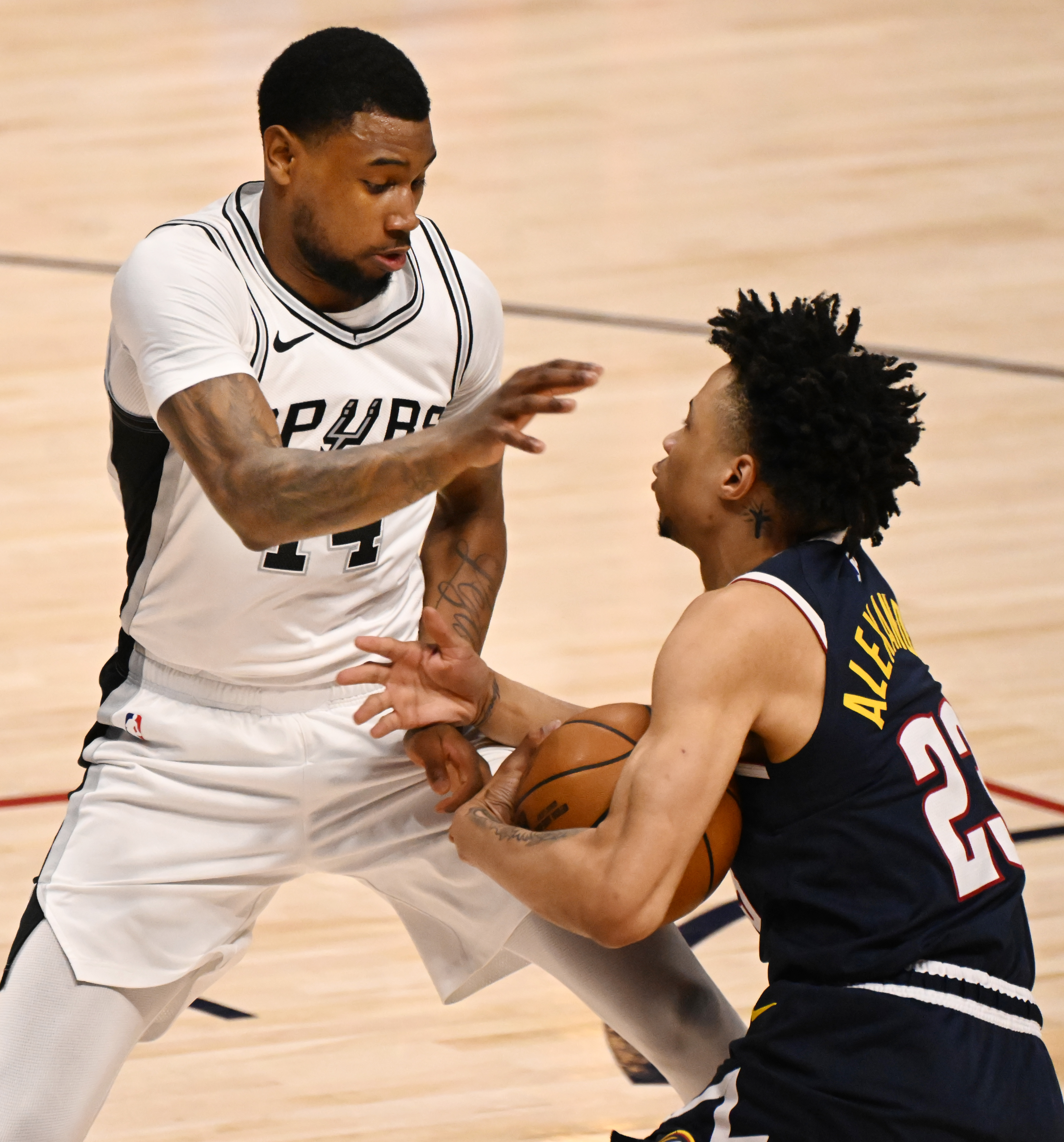 Spurs Blake Wesley and Nuggets Trey Alexander fight for the ball in the second quarter during a game at Ball Arena on Wednesday, April 2, 2025. (Jerilee Bennett,The Gazette)