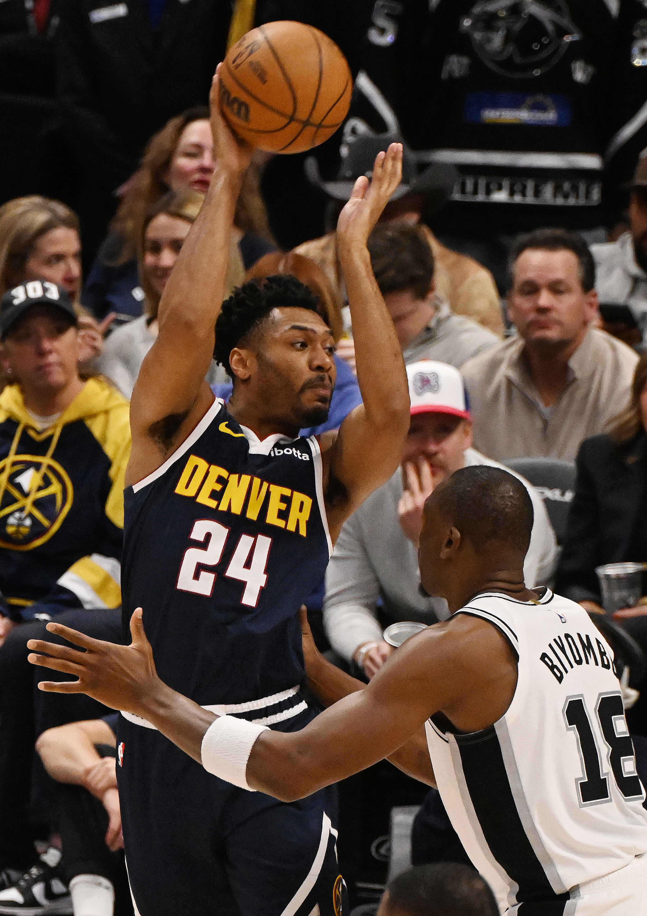 Nuggets Jalen Picket goes up to pass the ball past Spurs Bismack Biyombo in the 3rt quarter during a game at Ball Arena on Wednesday, April 2, 2025. (Jerilee Bennett,The Gazette)