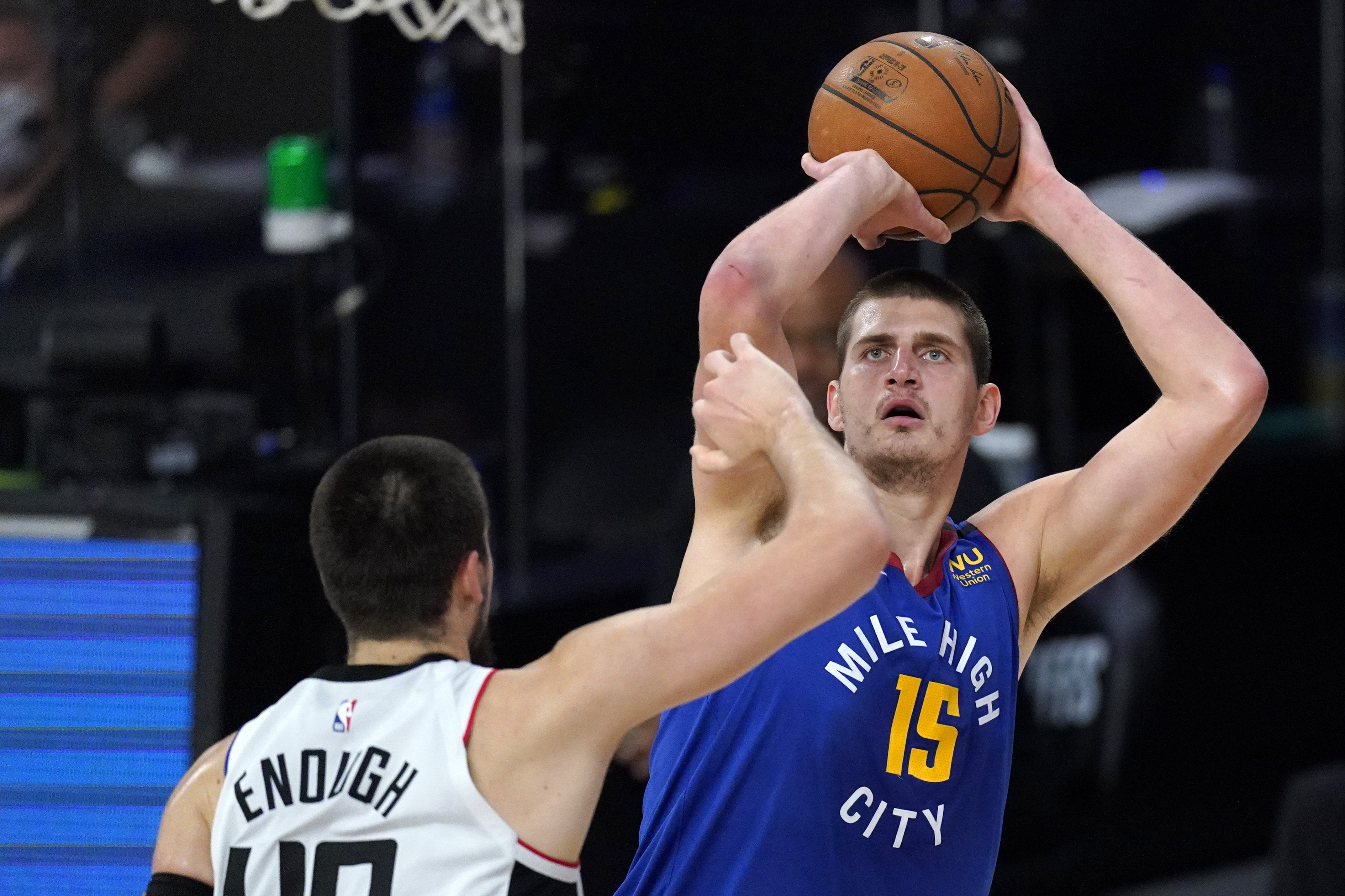 The Nuggets’ Nikola Jokic, right, goes up for a shot against the Clippers’ Ivica Zubac during the first half of their Western Conference semifinal playoff game Friday in Lake Buena Vista, Fla. (Photos by The Associated Press)