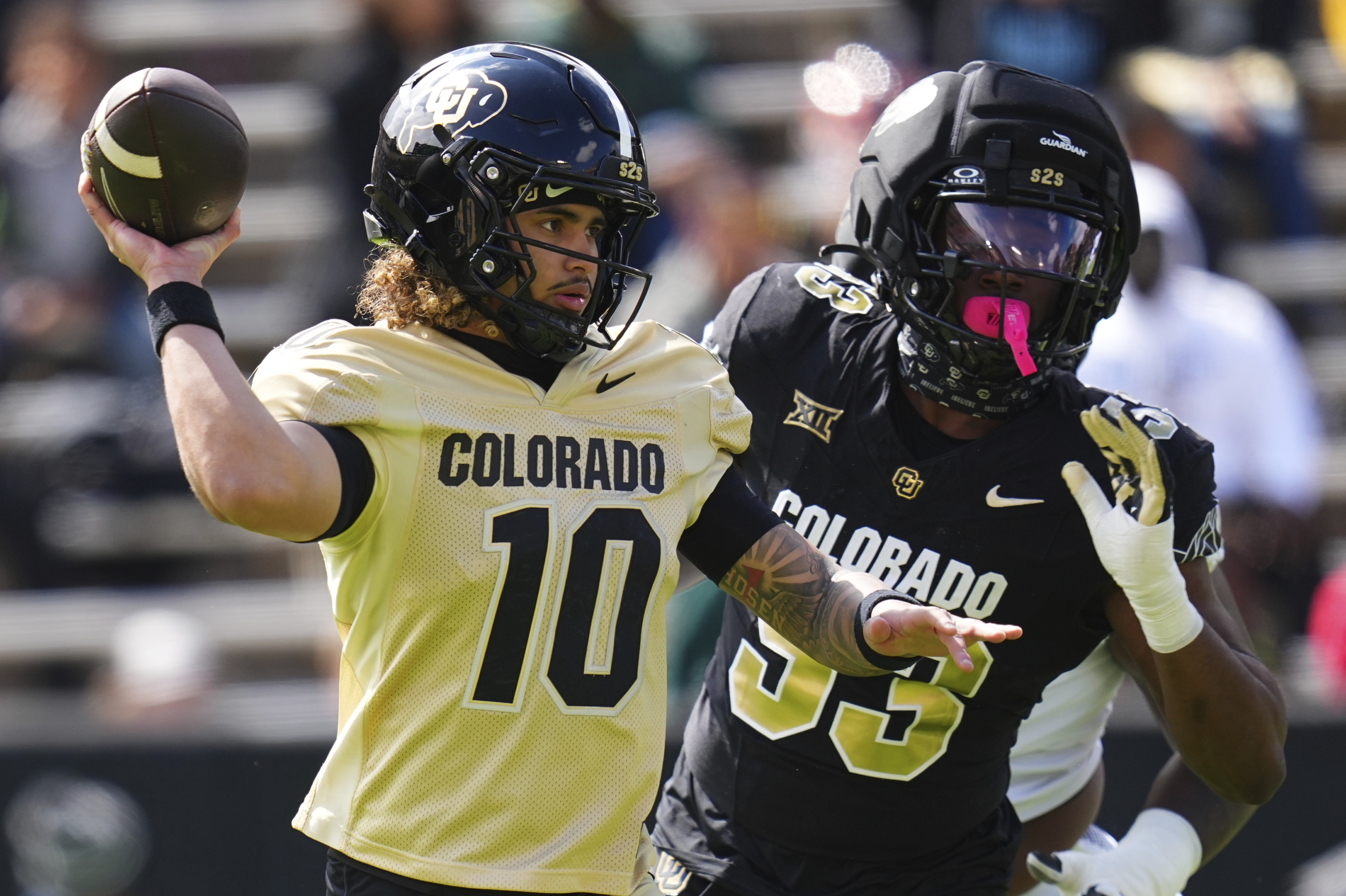 Colorado quarterback Julian Lewis (10) throws under pressure from defensive end Arden Walker (53) during Colorado's NCAA college football spring game, Saturday, April 19, 2025, in Boulder, Colo. (AP Photo/Jack Dempsey) (Jack Dempsey)