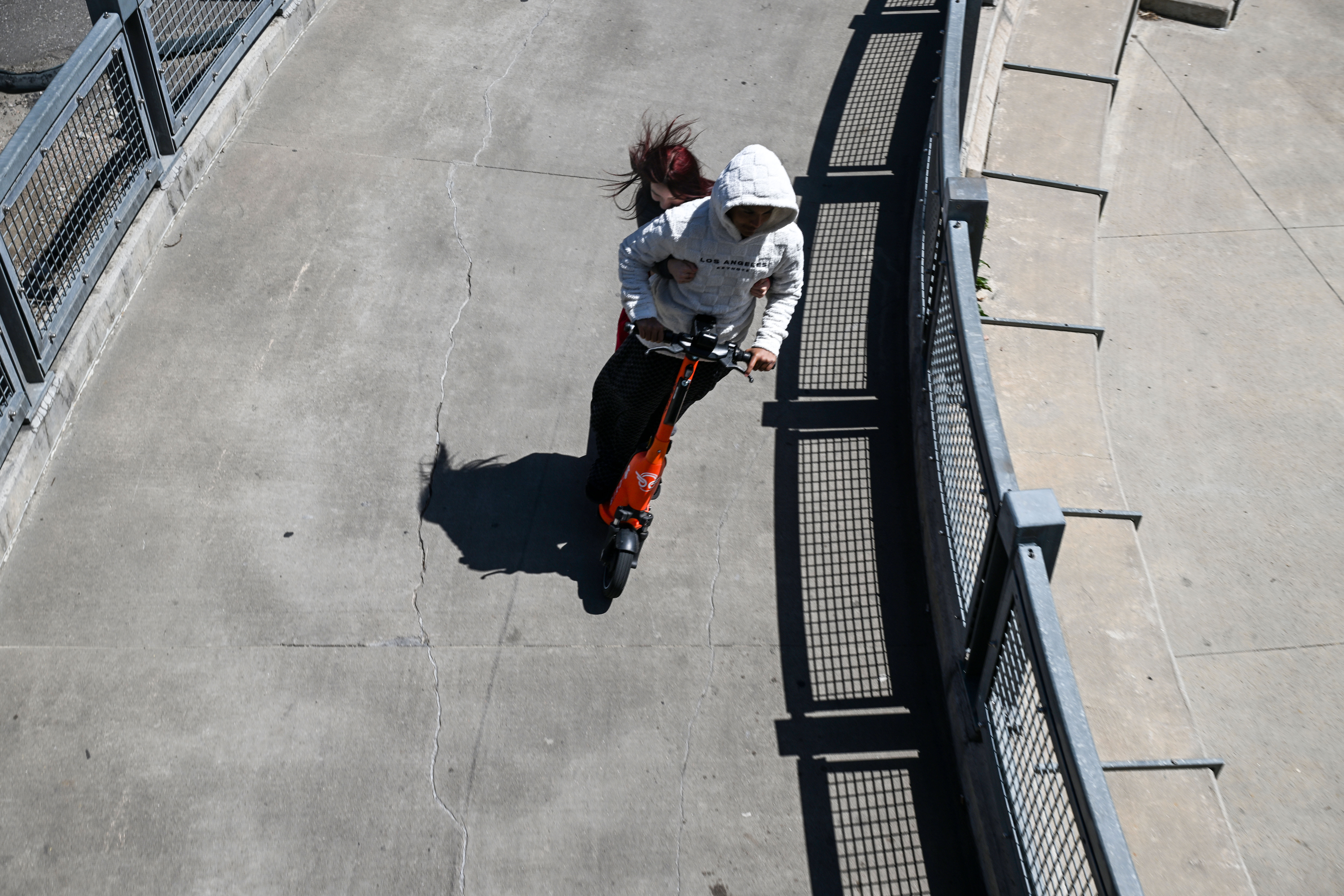 Chuy Ortega and Jocelyn Alba, both 14, ride a rental scooter across the Highland Bridge in downtown Denver on Tuesday, April 29, 2025. (Stephen Swofford, Denver Gazette) (StephenSwoffordPhotographerstephen.swofford@gazette.comhttps://secure.gravatar.com/avatar/1ddcaf11c5d70eaa58546ddc4e038687?d=mm&r=g)