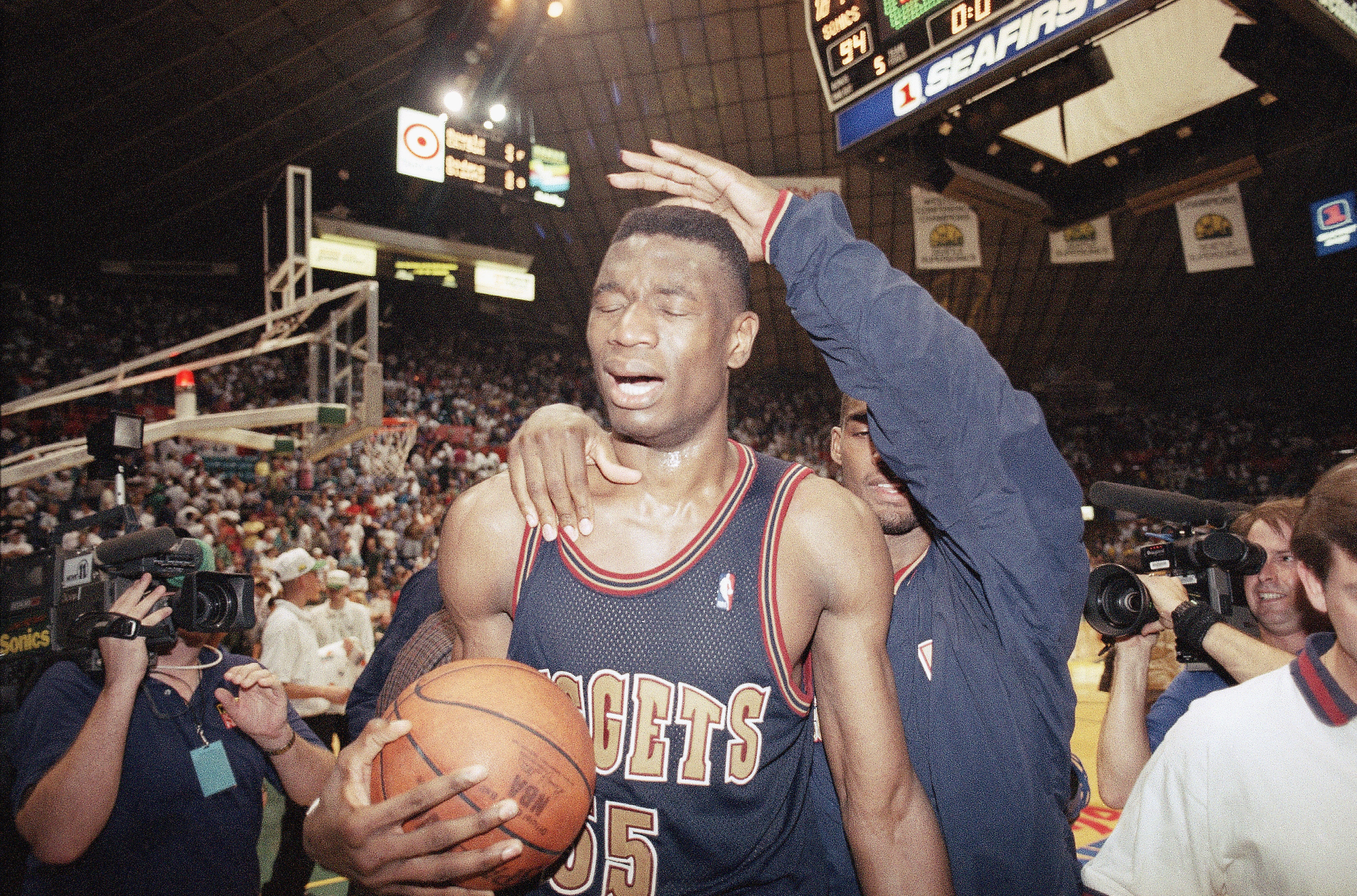 A stunned Denver Nuggets' Dikembe Mutombo leaves the floor Saturday, May 7, 1994, in Seattle after the Nuggets upset the Seattle SuperSonics 98-94 to take the best-of five series 3-2. (AP Photo/Gary Stewart) (GARY STEWART)