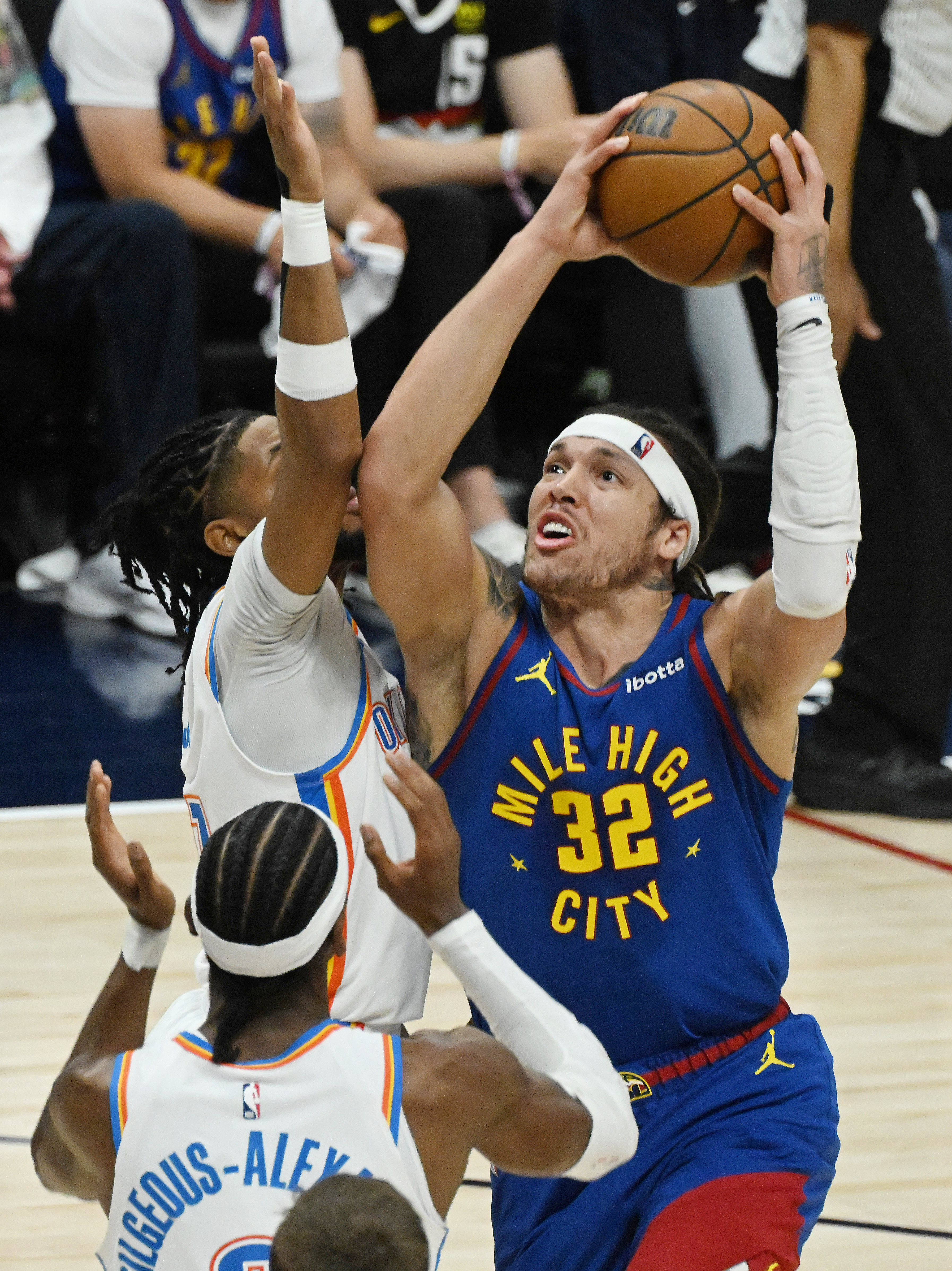 Denver Nuggets forward Aaron Gordon (32) goes up for a shot over Oklahoma City Thunder guard Isaiah Joe (11) and Oklahoma City Thunder guard Shai Gilgeous-Alexander (2) during the first quarter of game 3 of round 2 of the Western Conference Championship at Ball Arena on Friday, May 9, 2025. (Jerilee Bennett,The Gazette)