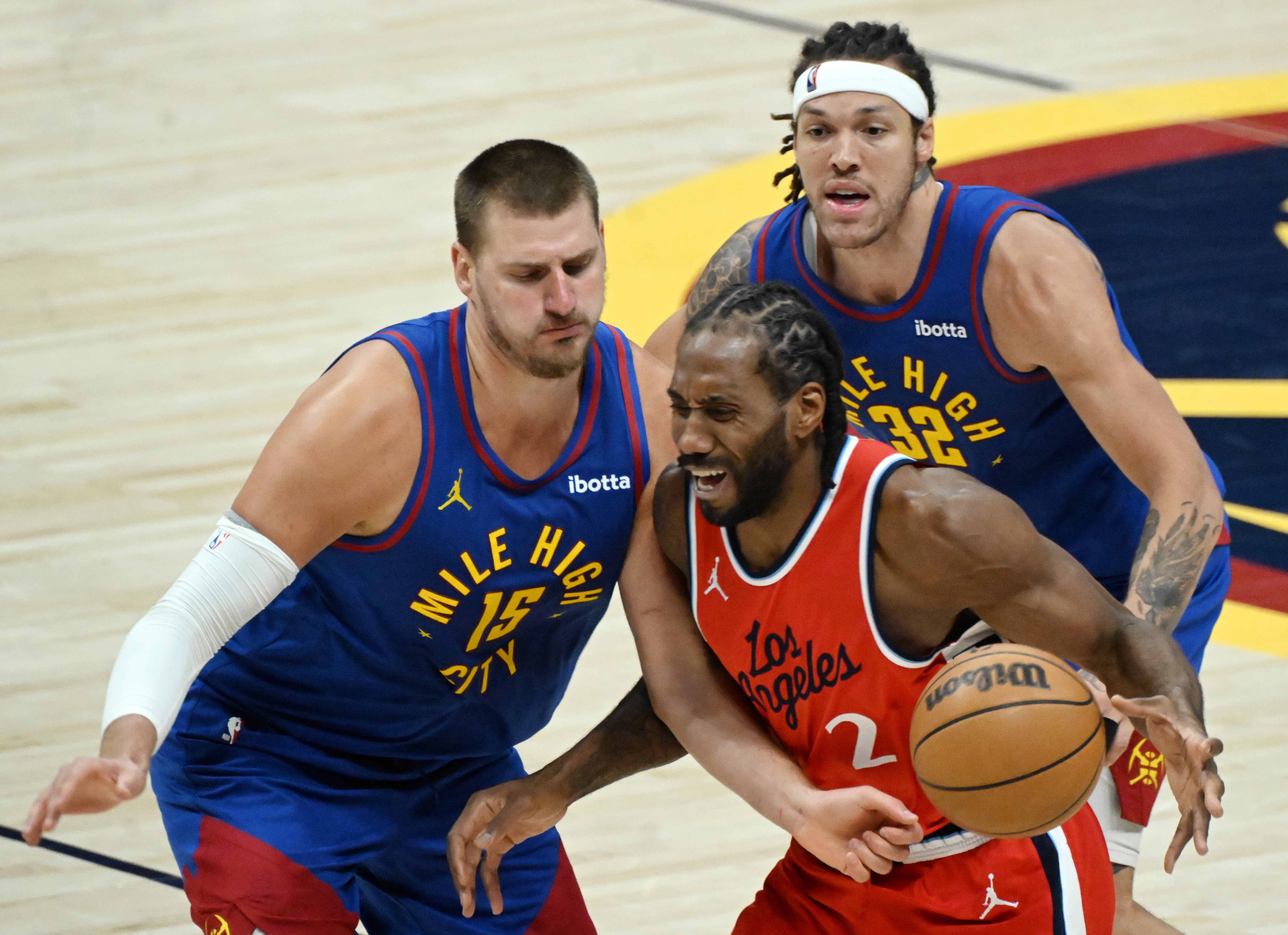 Denver Nuggets center Nikola Jokic (15) and Denver Nuggets forward Aaron Gordon (32) put pressure on LA Clippers forward Kawhi Leonard (2) during the third quarter ofGame 7 of Round 1 of the Western Conference Championship on Saturday, April 3, 2025. The Nuggets defeated the Clippers 120-101 and will play the Thunder in the second round. (Jerilee Bennett,The Gazette)