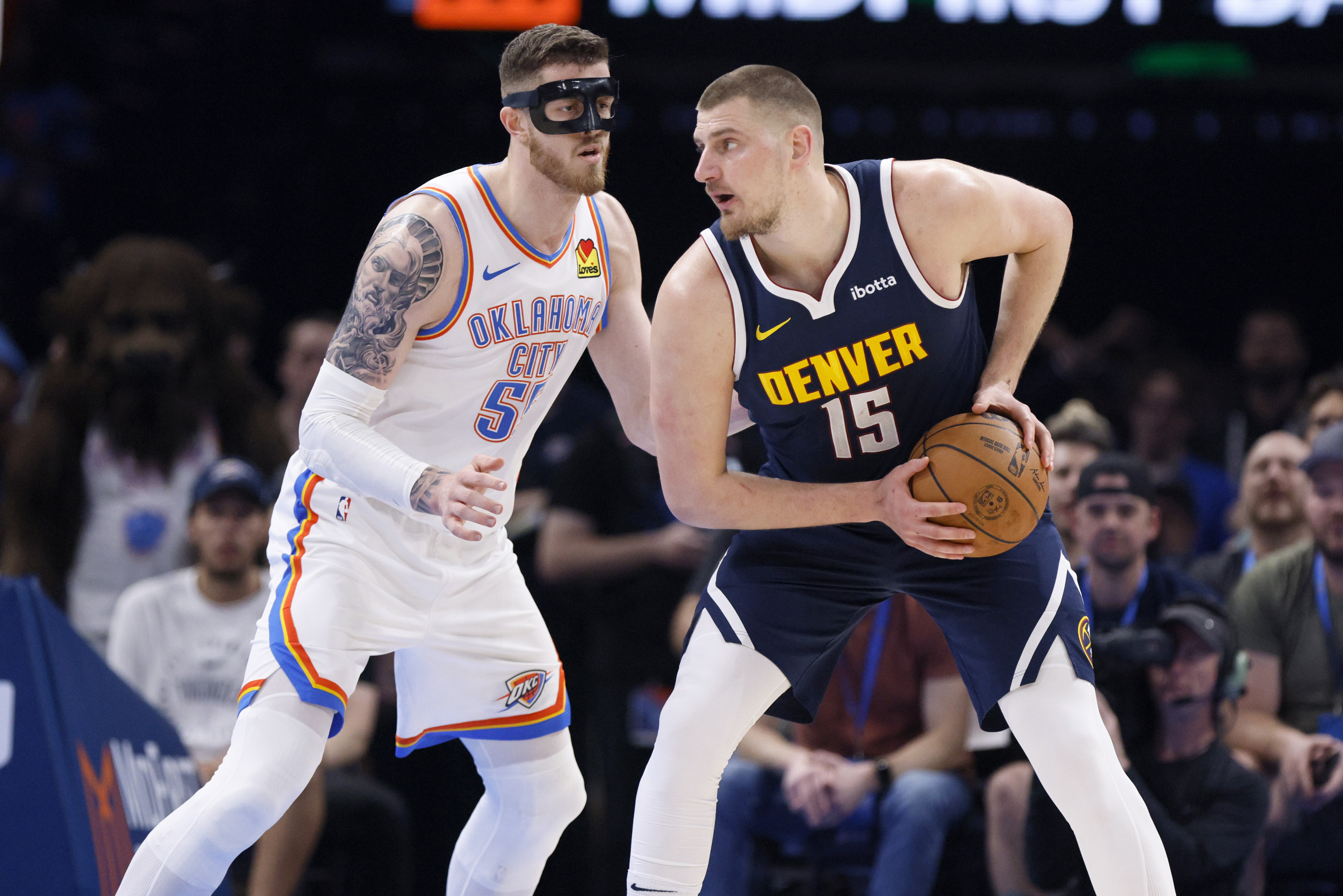 Denver Nuggets center Nikola Jokic (15) looks for an outlet against Oklahoma City Thunder center Isaiah Hartenstein, left, during the first half of an NBA basketball game Monday, March 10, 2025, in Oklahoma City. (AP Photo/Nate Billings) (Nate Billings)