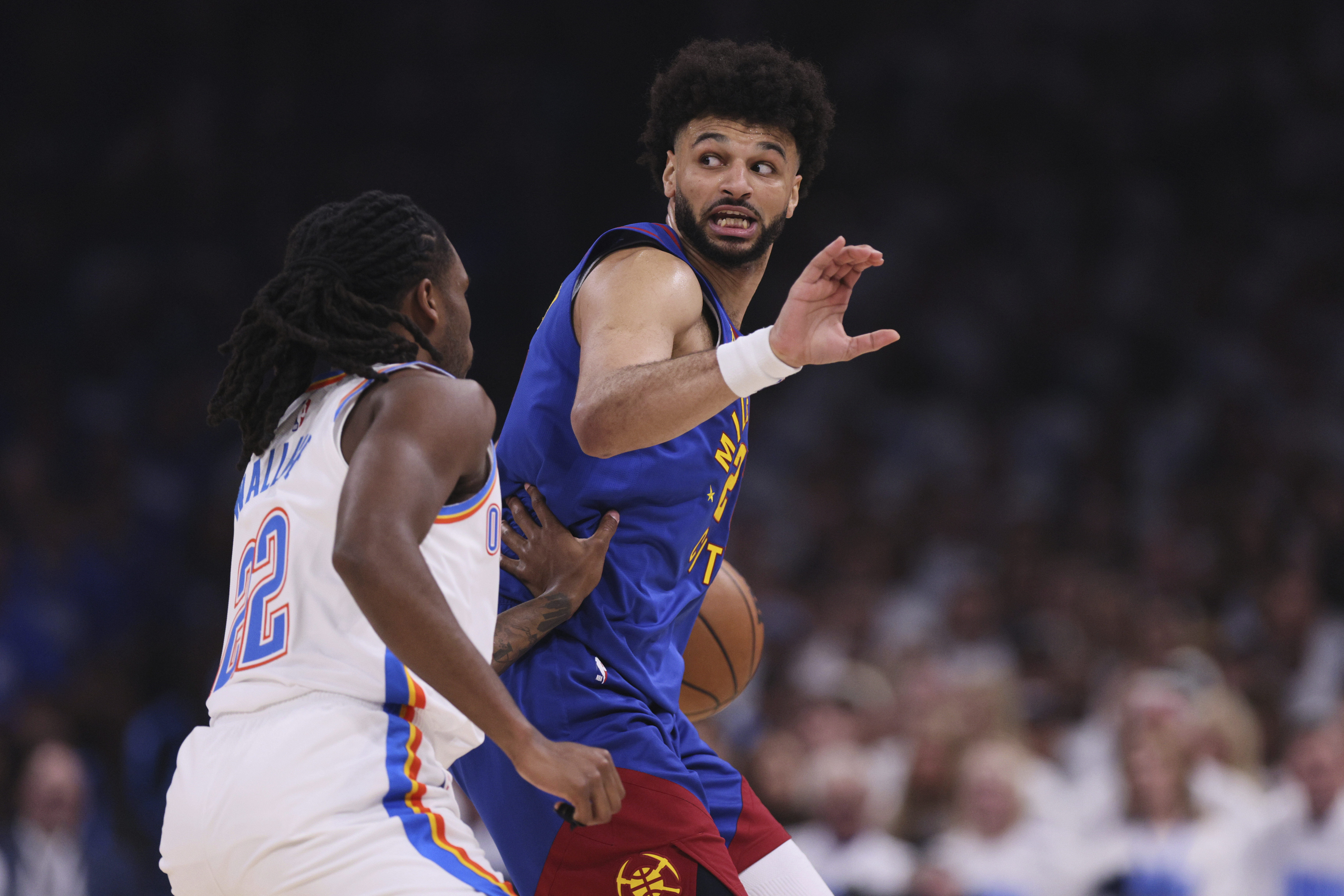 Denver Nuggets' Jamal Murray (27) signals as Oklahoma City Thunder's Cason Wallace (22) defends in the first half of Game 5 of an NBA basketball second-round playoff series Tuesday, May 13, 2025, in Oklahoma City. (AP Photo/Nate Billings) (Nate Billings)