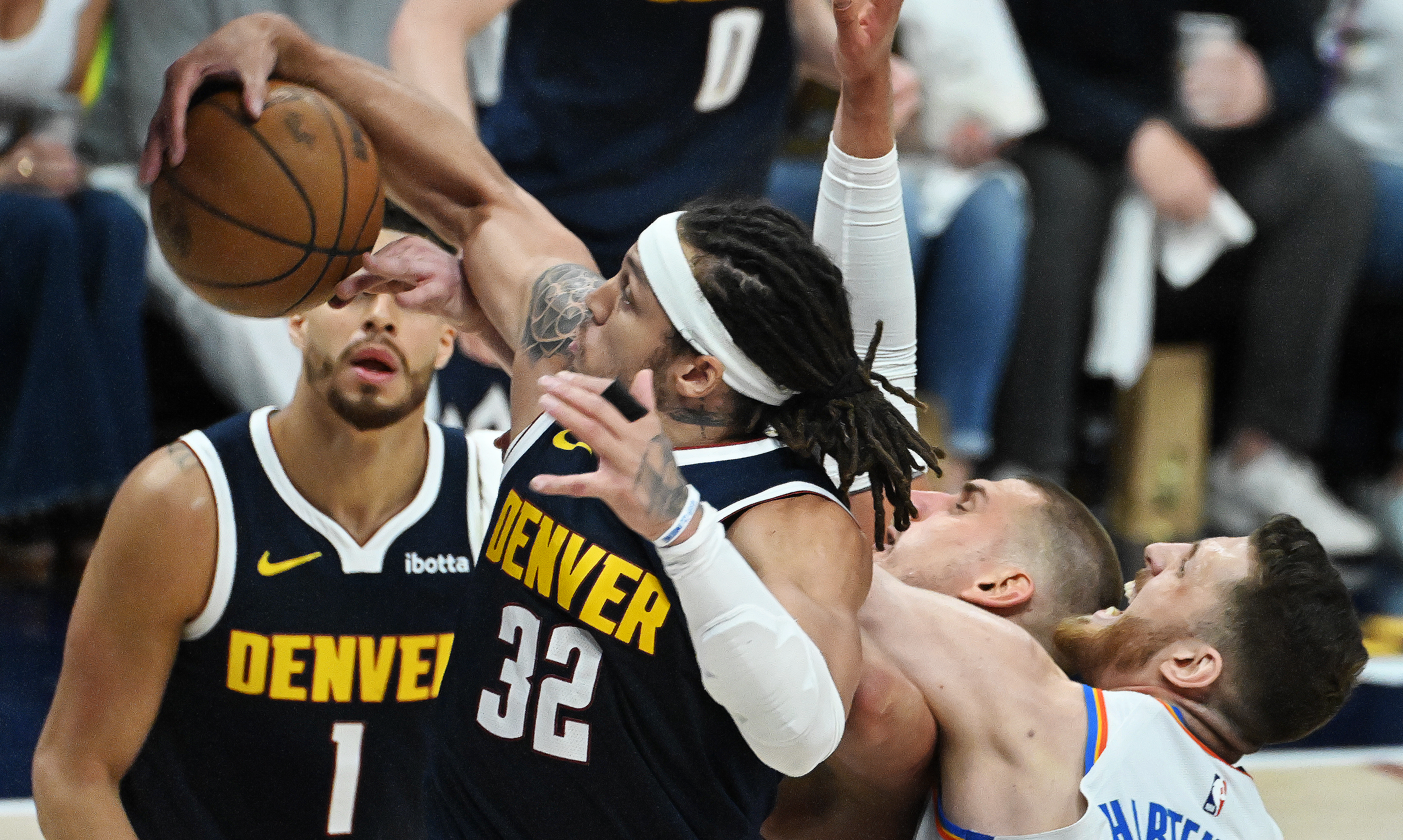 Denver Nuggets forward Aaron Gordon (32) pulls down a defensive rebound while Denver Nuggets center Nikola Jokic (15) gets tangled with Oklahoma City Thunder center Isaiah Hartenstein (55) during the 3rd quarter of game 4 of the second round of the Western Conference Championship at Ball Arena on Sunday, May 11, 2025. (Jerilee Bennett,The Gazette)