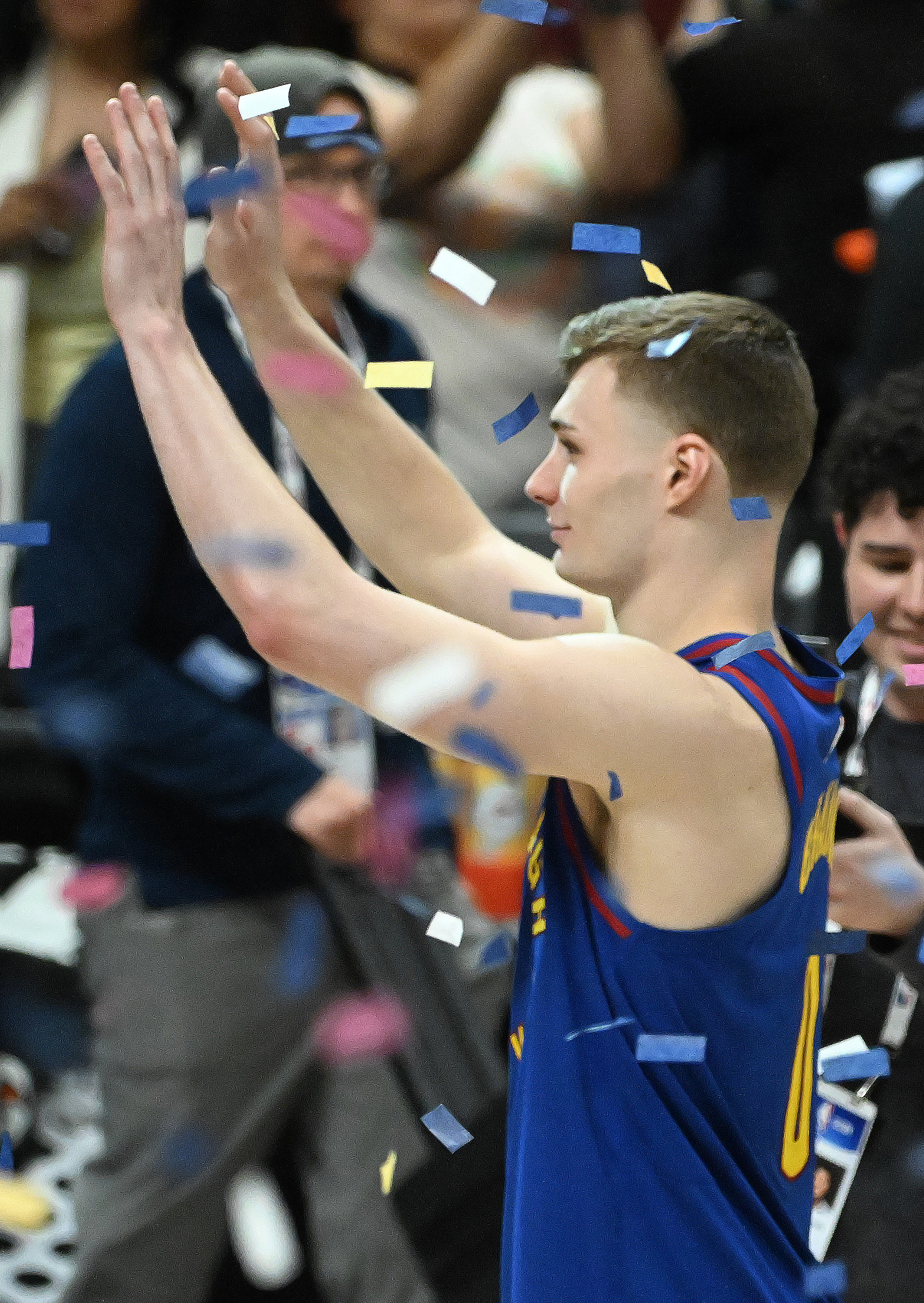 Denver Nuggets guard Christian Braun (0) waves to the crowd through the confetti after Game 7 of Round 1 of the Western Conference Championship on Saturday, April 3, 2025. The Nuggets defeated the Clippers 120-101 and will play the Thunder in the second round. (Jerilee Bennett,The Gazette)