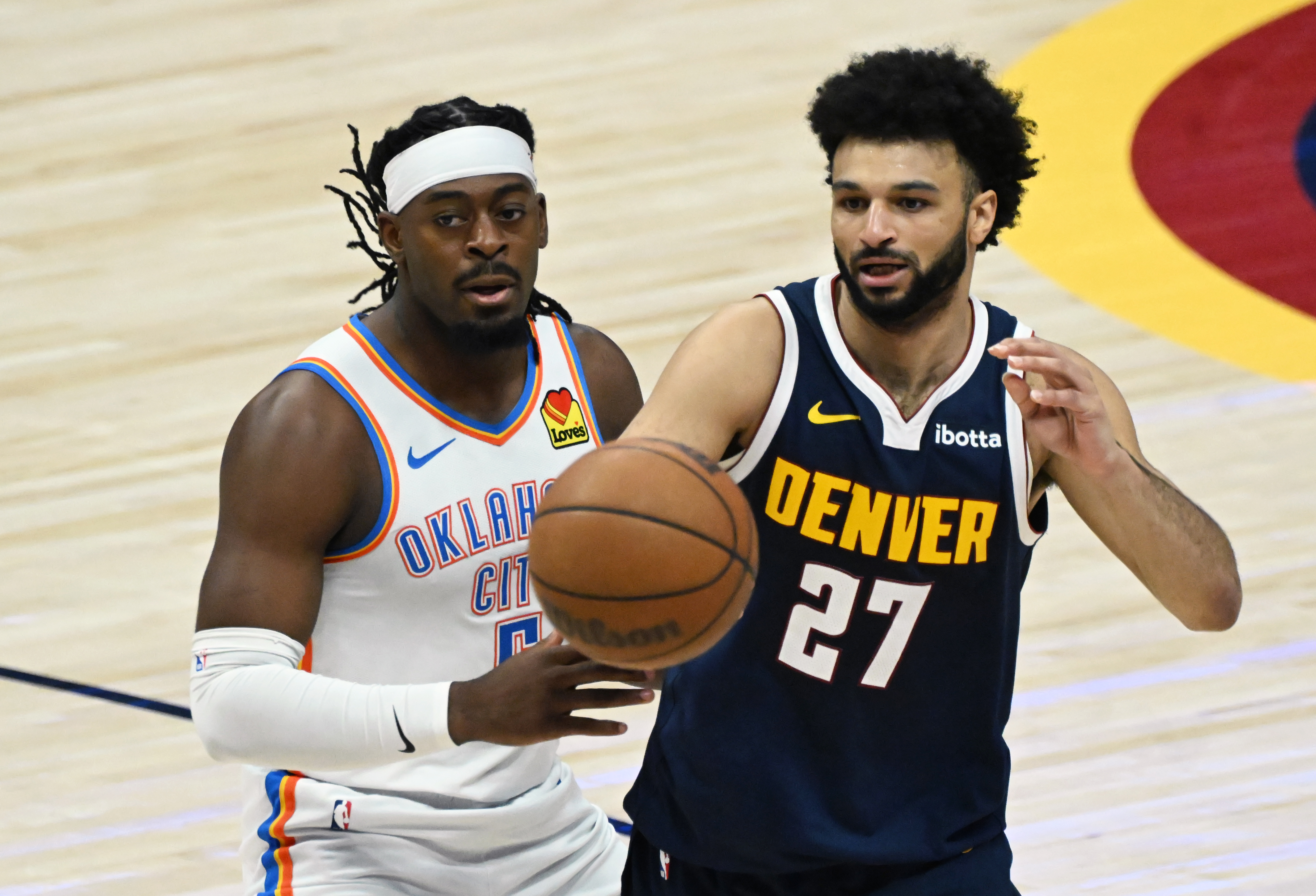 Denver Nuggets guard Jamal Murray (27) passes the ball while being defended by Oklahoma City Thunder guard Luguentz Dort (5) during the 2nd quarter of game 4 of the second round of the Western Conference Championship at Ball Arena on Sunday, May 11, 2025. (Jerilee Bennett,The Gazette)
