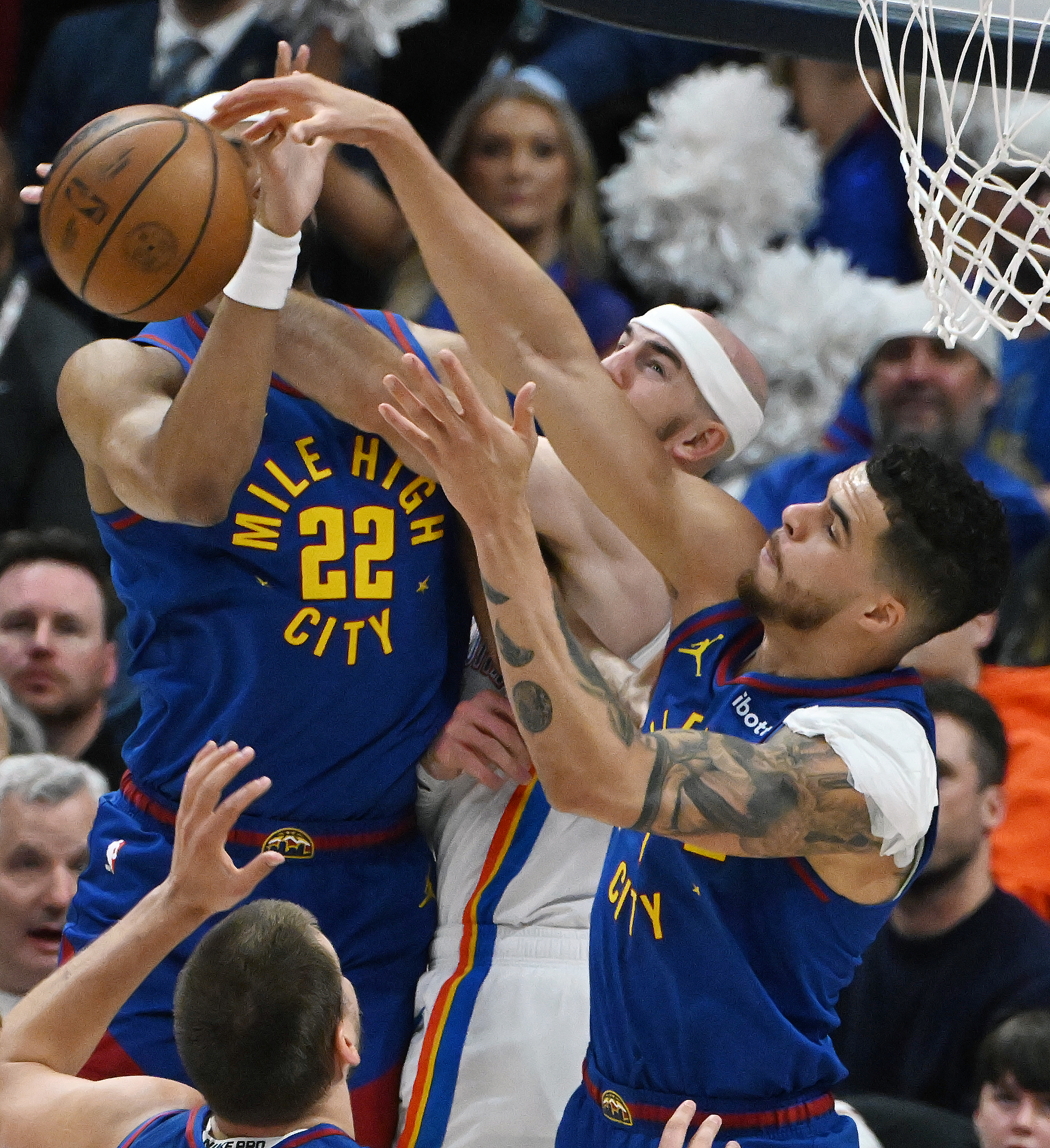 Denver Nuggets forward Michael Porter Jr. (1) fights for the ball with Oklahoma City Thunder guard Alex Caruso (9) and Denver Nuggets forward Zeke Nnaji (22) (right to left) during the 2nd quarter of game 3 of round 2 of the Western Conference Championship at Ball Arena on Friday, May 9, 2025. (Jerilee Bennett,The Gazette)