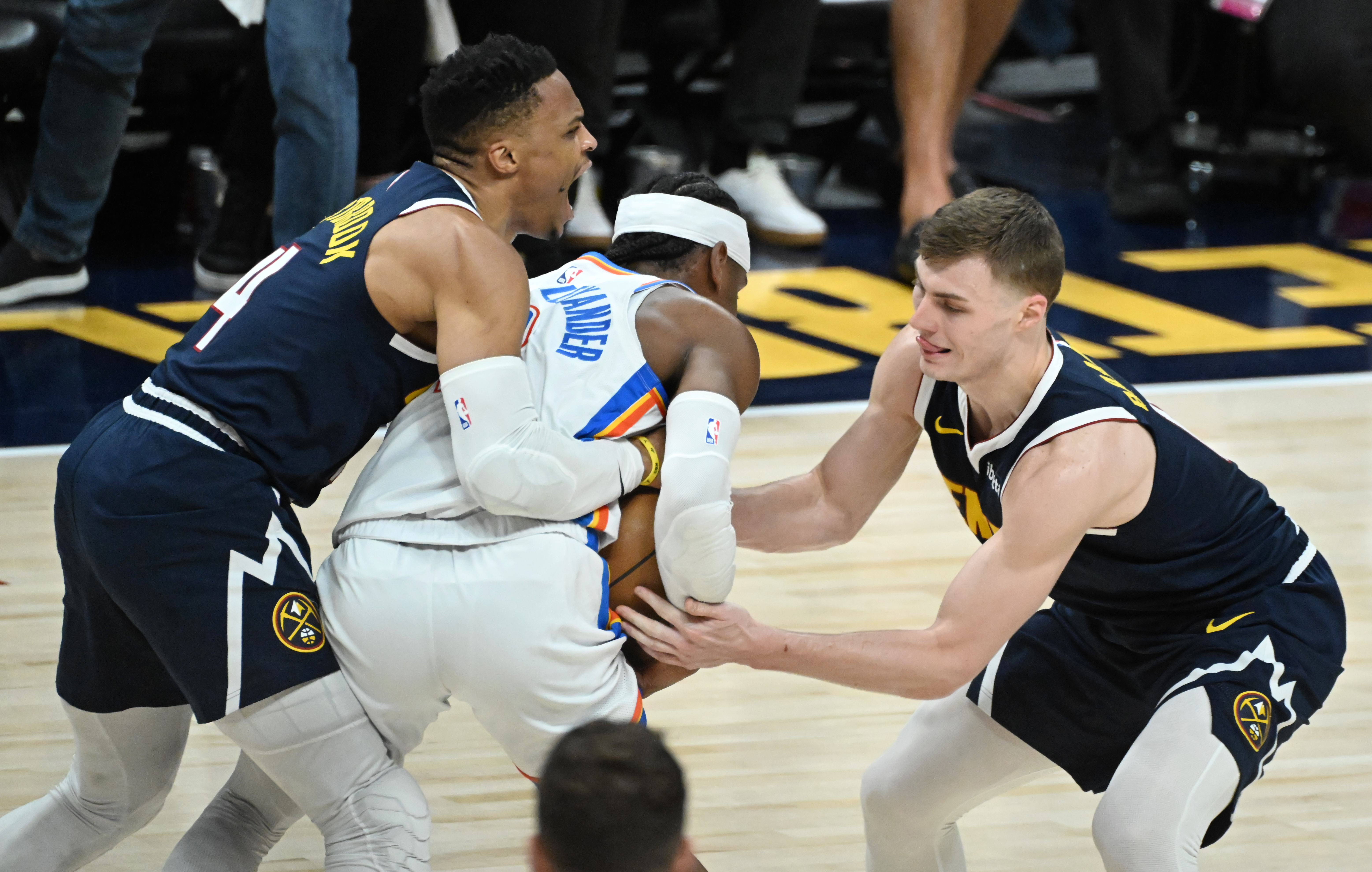 Denver Nuggets guard Russell Westbrook (4) and Denver Nuggets guard Christian Braun (0) fight Oklahoma City Thunder guard Shai Gilgeous-Alexander (2) for the ball during the 3rd quarter of game 4 of the second round of the Western Conference Championship at Ball Arena on Sunday, May 11, 2025. (Jerilee Bennett,The Gazette)