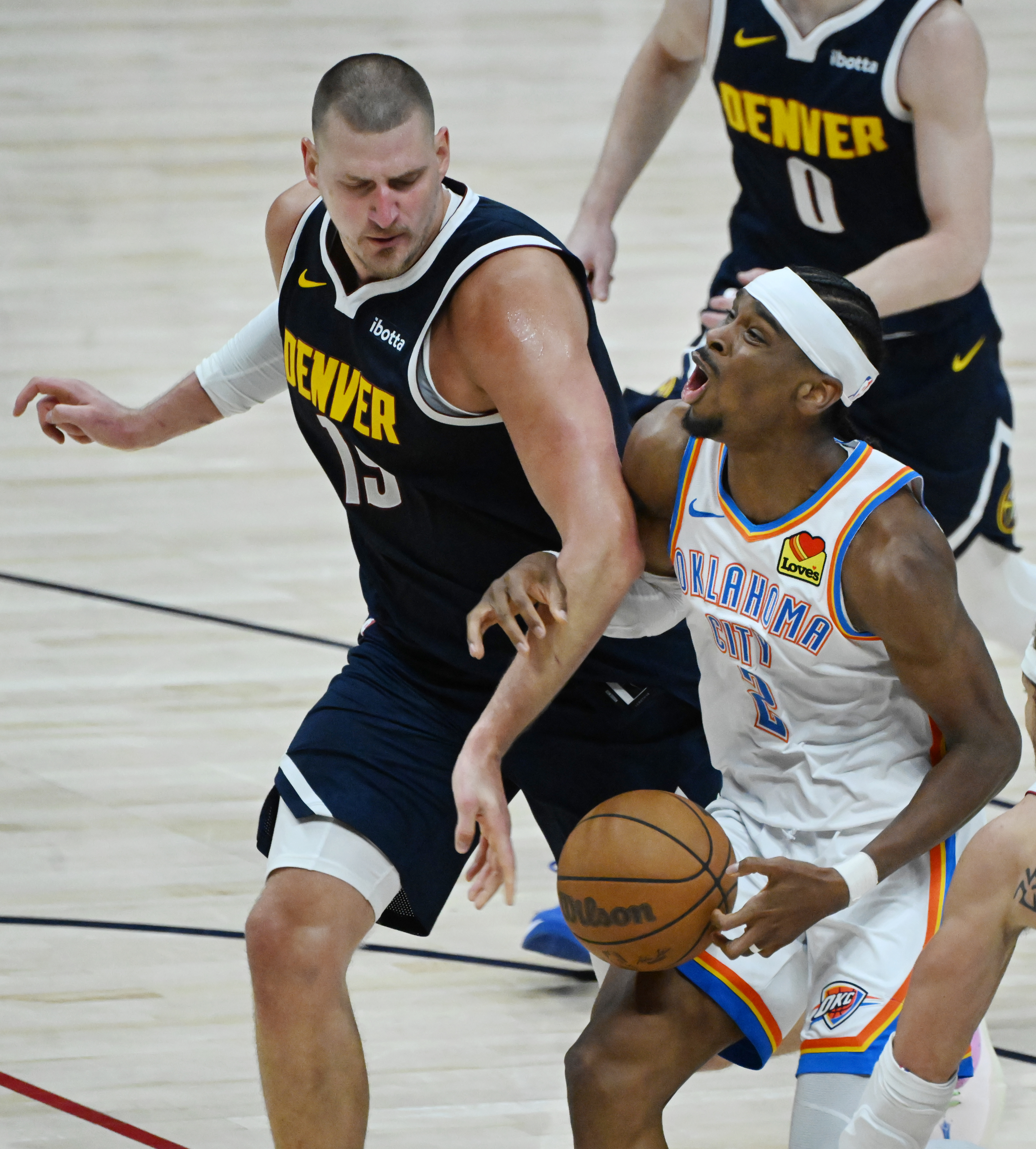Denver Nuggets center Nikola Jokic (15) knocks the ball away from Oklahoma City Thunder guard Shai Gilgeous-Alexander (2) during the 4th quarter of game 4 of the second round of the Western Conference Championship at Ball Arena on Sunday, May 11, 2025. (Jerilee Bennett,The Gazette)